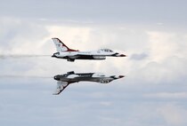 MINOT AIR FORCE BASE, N.D. -- Two U.S. Air Force Thunderbird aircraft perform a reflection pass during Northern Neighbor’s Day here Sept. 8. Inclement weather cleared up just in time for the Thunderbirds to perform, to the delight of many people waiting to see the Air Force’s premier aerial demonstration team. The Thunderbirds perform precision aerial maneuvers to exhibit the capabilities of modern high-performance aircraft to people throughout the world. The pilots performed approximately 40 maneuvers during the demonstration. (U.S. Air Force photo by Senior Airman Christopher Boitz)