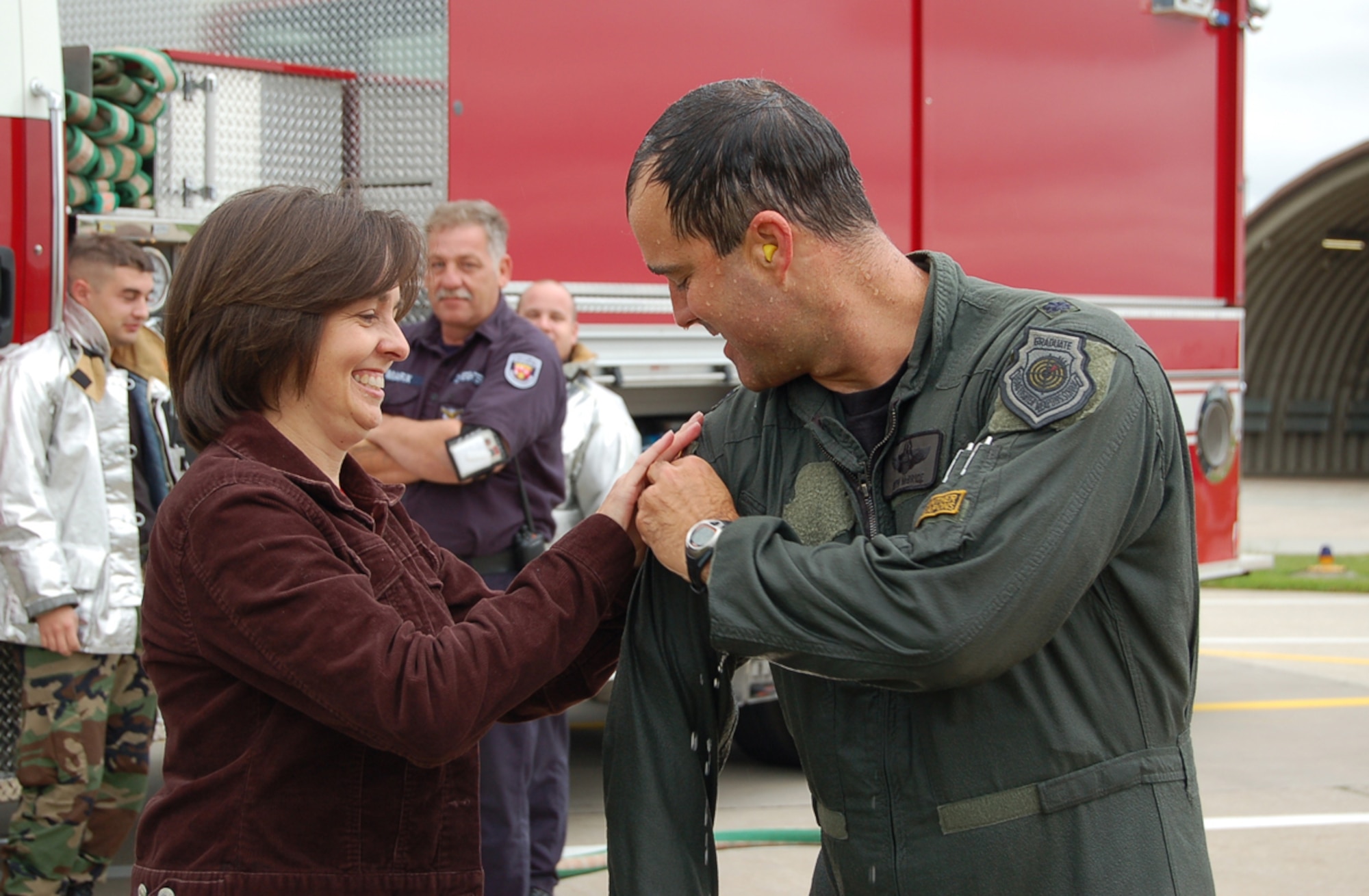 SPANGDAHLEM AIR BASE, Germany – Julie McBride, wife of Lt. Col. Keith McBride, attaches a 3,000 flying hours patch to the colonel’s flight suit after the colonel completed 3,000 flying hours Sept. 6. The colonel said he was thrilled and proud of his accomplishment. He has served 19 years in the Air Force and has been flying the A-10 for 14 and a half years. (U.S. Air Force photo/Staff Sgt. Andrea Knudson)