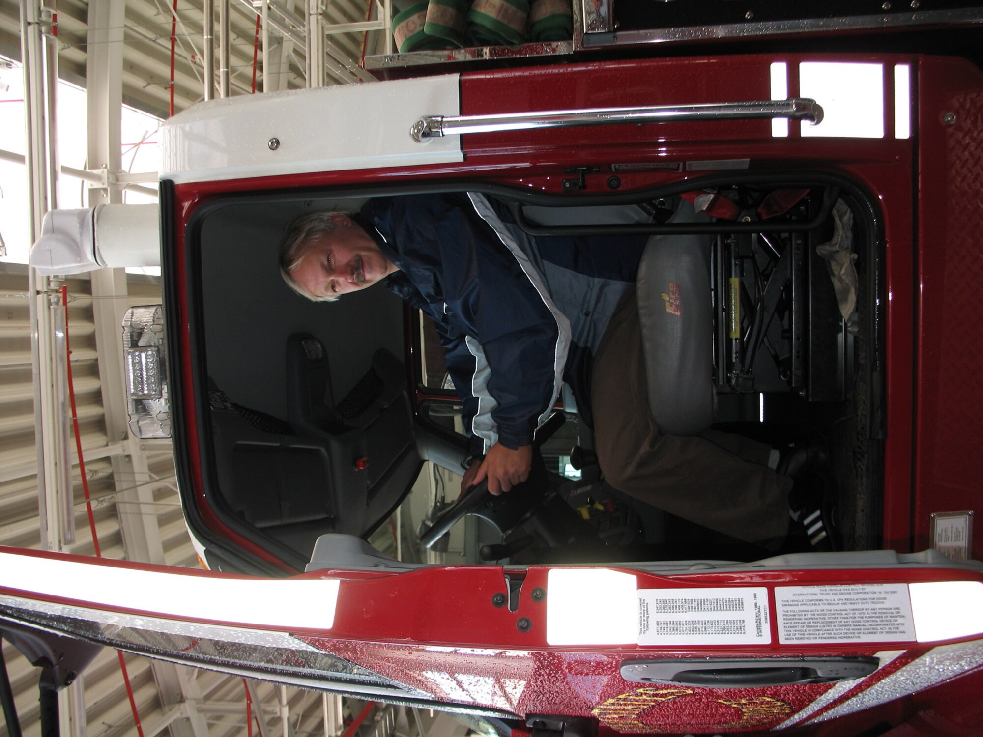 SPANGDAHLEM AIR BASE, Germany -- Heinz Ferring, Bitburg Police Station chief inspector, spends a moment in the cab of a Spangdahlem Air Base fire truck during the police station’s work outing Sept. 4, 2007. (U.S. Air Force photo/ Simone Chapman)