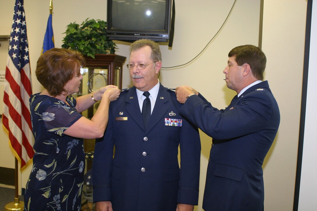 Colonel Guy Lindholm is pinned by his wife, Sharon, and Col. Dennis Daley, Special Assistant to the Commander, 482nd Fighter Wing during his promotion ceremony on September 8. (U.S. Air Force photo/Tech. Sgt. Paul Dean)
