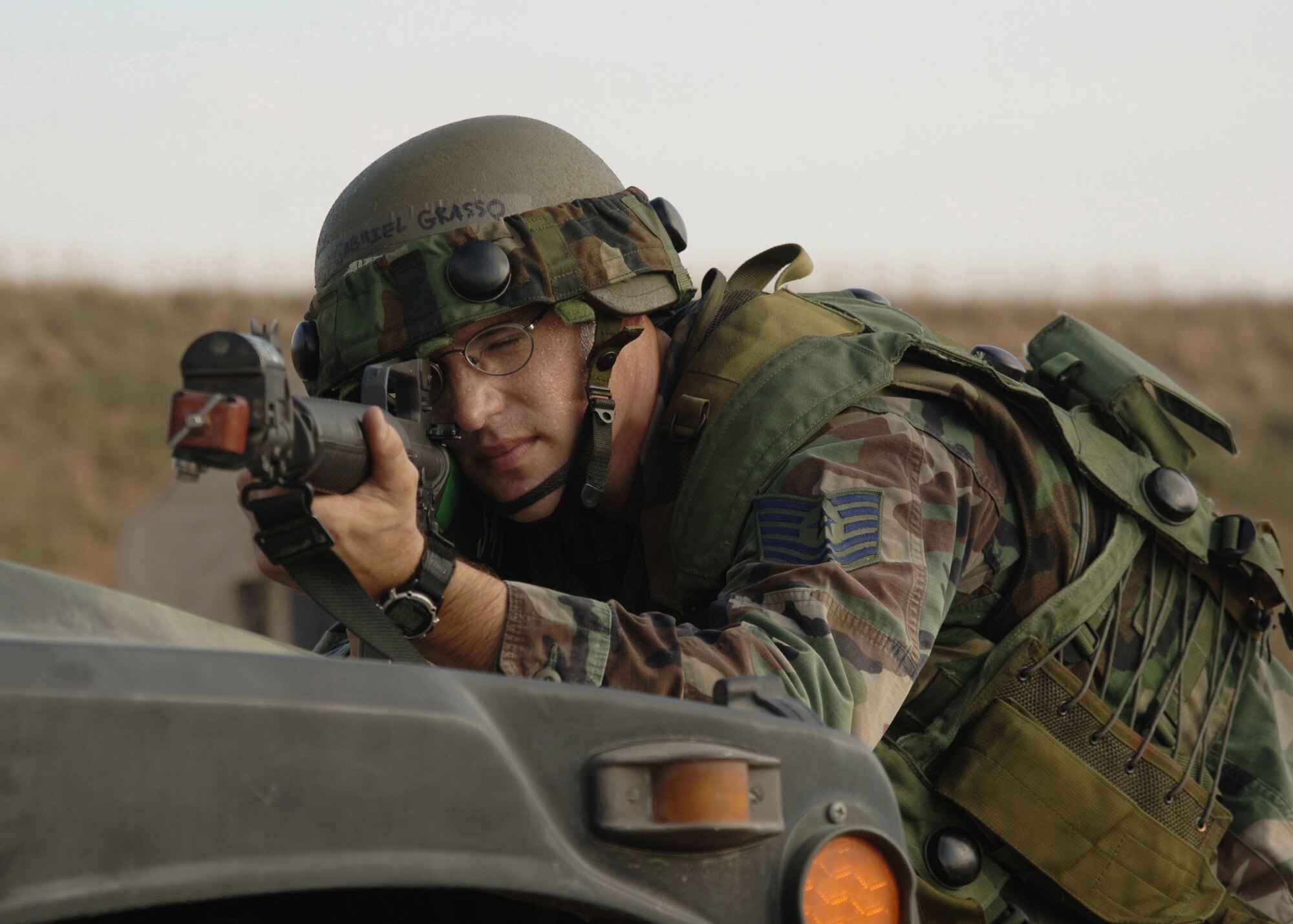 Tech Sgt. Gabriel Grasso, 39th Logistics Readiness Squadron, uses a Humvee for cover while returning fire at opposing forces during an Air Expeditionary Force training exercise for future deployments Aug. 31. This is the first time Incirlik has had the training allowing Airmen to get out in the field and practice what they have learned for upcoming deployments. (U.S. Air Force photo by Senior Airman Tiffany Colburn)(RELEASED)