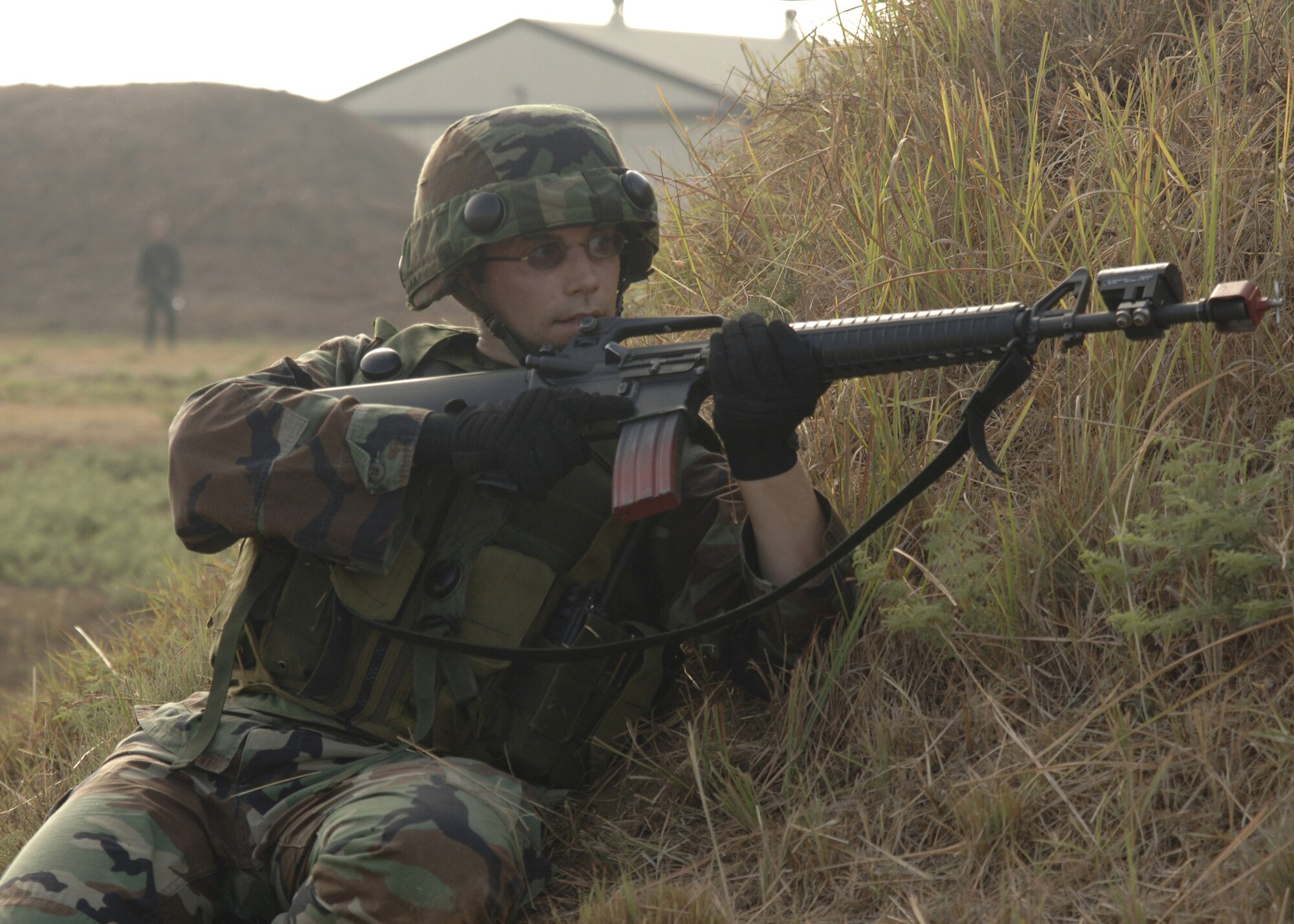 Tech. Sgt. Orrin Hart, 39th Communications Squadron, keeps cover while returning fire during an Air Expeditionary Force training exercise Aug. 31. The training consisted of one day in the classroom and the one day out in the field to practice their skills. The training also allowed Airmen to train on convoy and force on force. (U.S. Air Force photo by Senior Airman Tiffany Colburn)(RELEASED)  