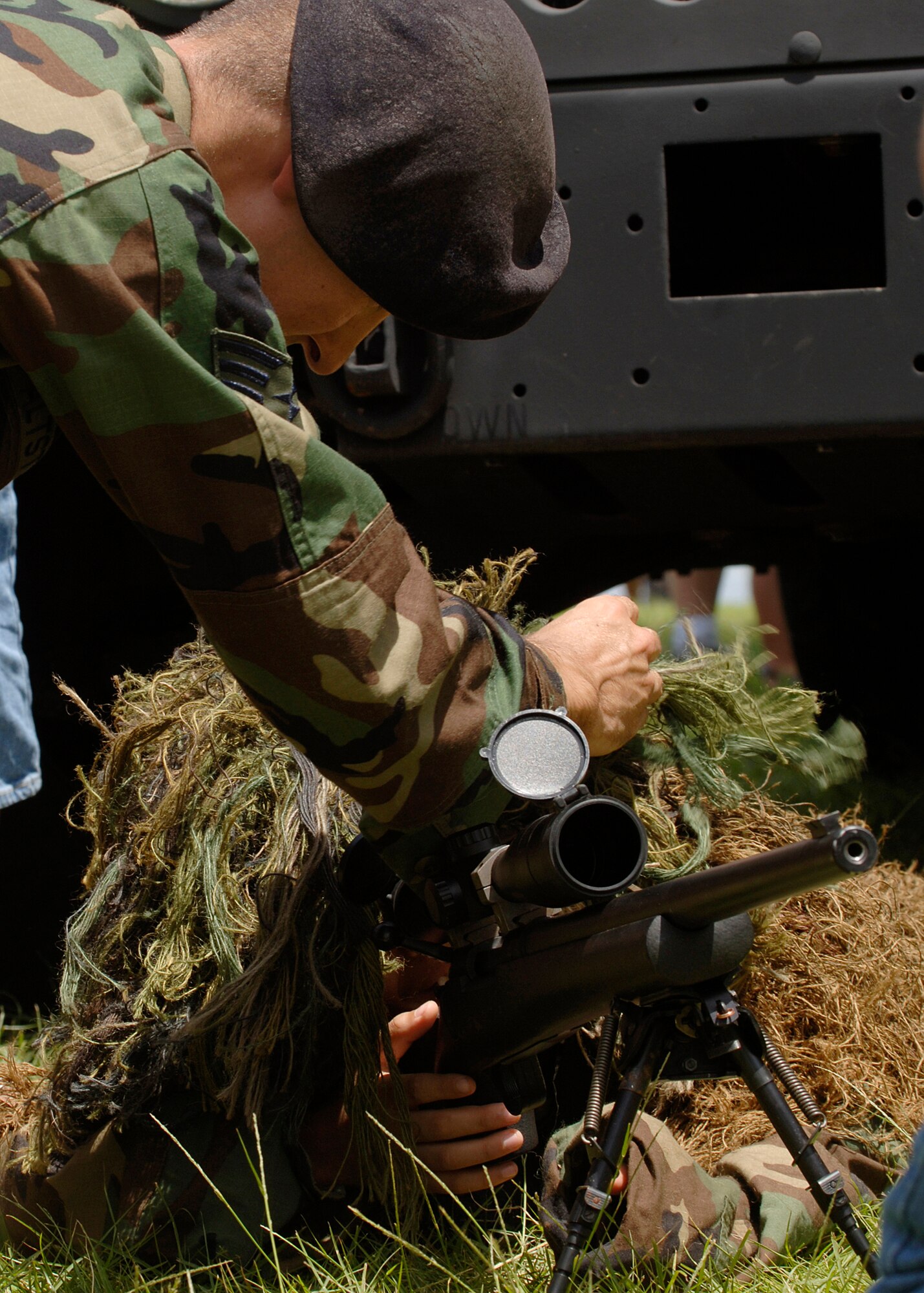 ANDERSEN AFB, GUAM - Senior Airman Kyle Altstaetter, 736th Security Forces Squadron, explains how to set the sights on a sniper rifle at Ypao Beach Sept. 8. The event was one of many held during Guam's Air Force week to honor the Air Force's 60th Anniversary. (Photo by Senior Airman Sonya Padilla)
