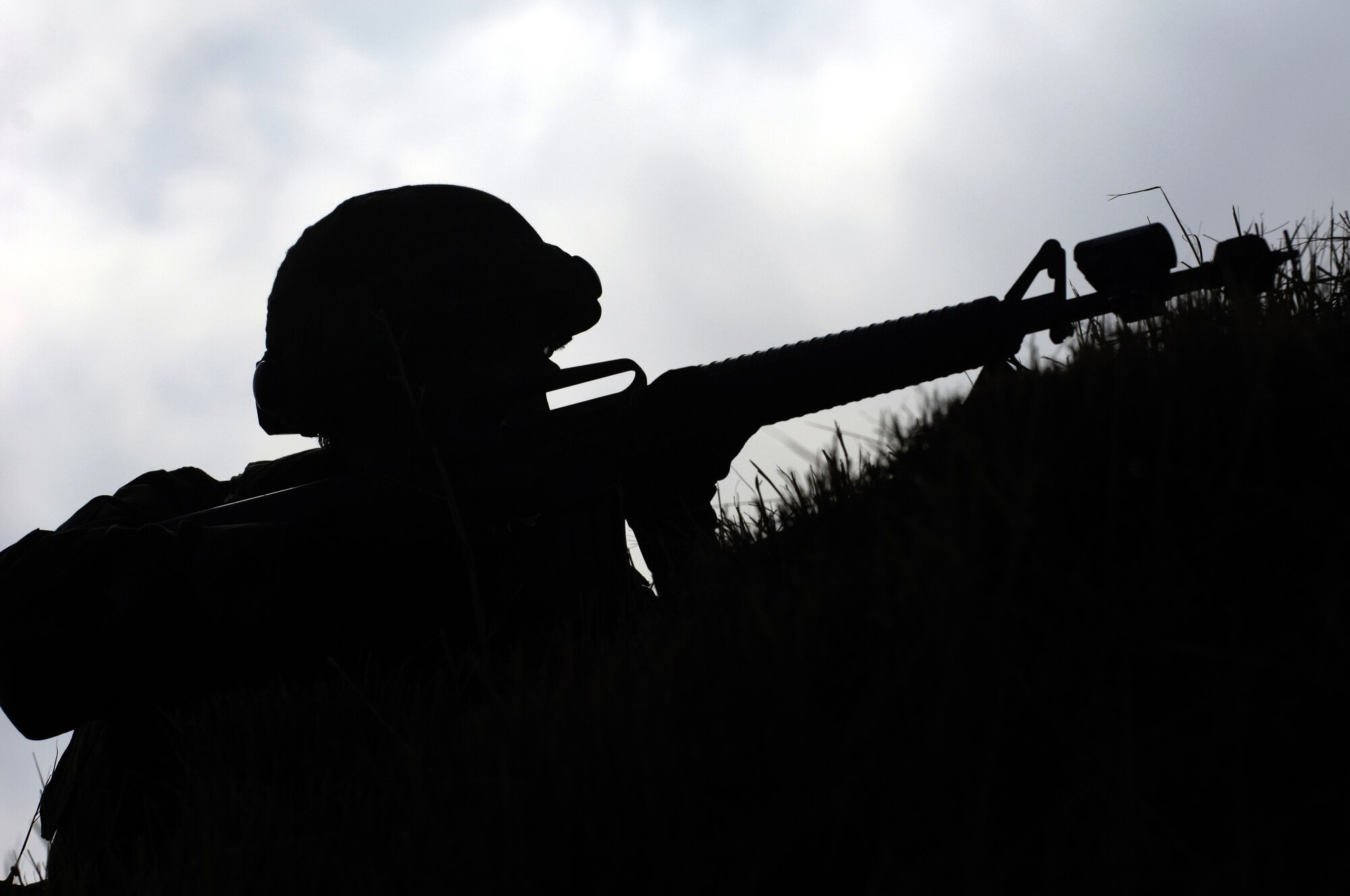 Tech. Sgt. Orrin Hart, 39th Communications Squadron, is silhouetted by the sun as he searches for opposing forces in the distance during convoy training on Incirlik Air Base, Turkey Aug. 31. The new convoy training program is for Airmen deploying from Incirlik. (U. S. Air Force photo by Airman 1st Class Nathan Lipscomb)(RELEASED)