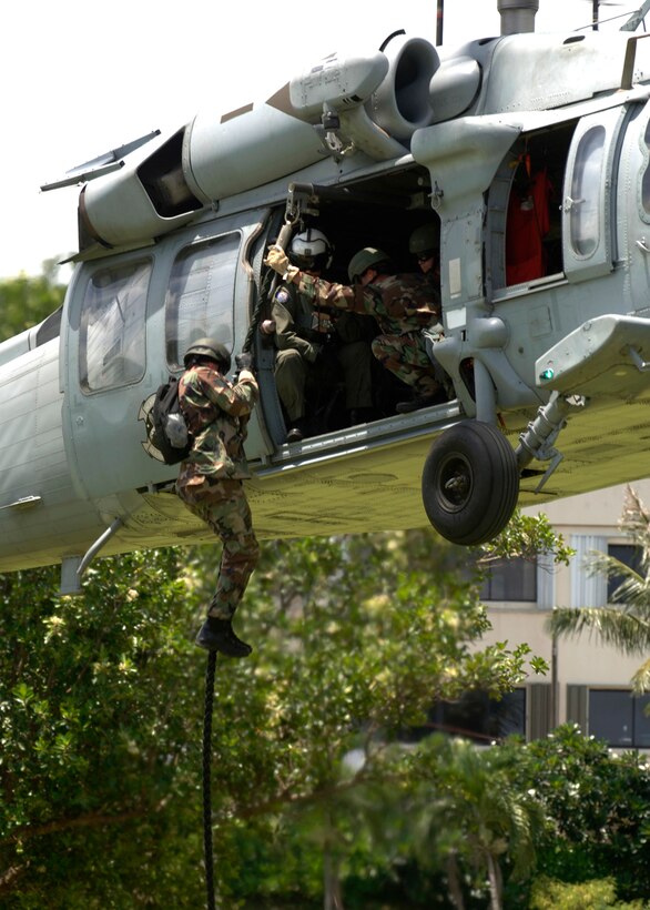 ANDERSEN AIR FORCE BASE GUAM, Members from the 554th RED HORSE Squadron and Helicopter Sea Combat Squadron 25 perform a fast-rope demonstration at Ypao Beach Sept 8. The event was one of many held during Air Force Week to honor the Air Force's 60th Anniversary. (Photo by Senior Airman Sonya Padilla)