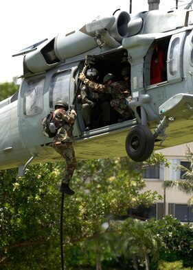 ANDERSEN AIR FORCE BASE GUAM, Members from the 554th RED HORSE Squadron and Helicopter Sea Combat Squadron 25 perform a fast-rope demonstration at Ypao Beach Sept 8. The event was one of many held during Air Force Week to honor the Air Force's 60th Anniversary. (Photo by Senior Airman Sonya Padilla)