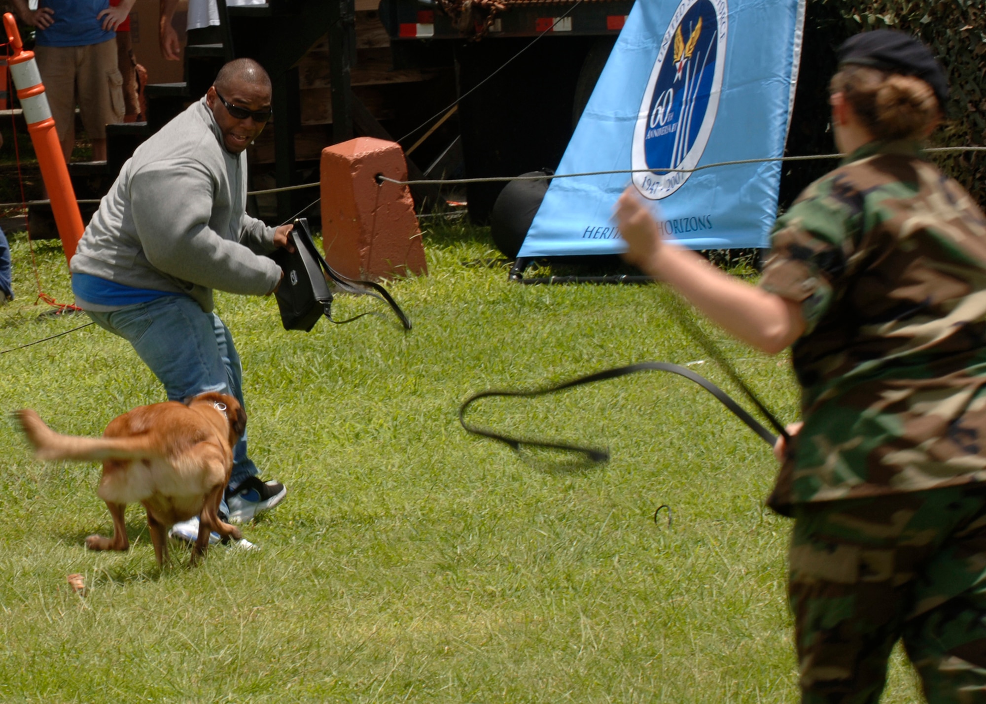 ANDERSEN AIR FORCE BASE GUAM, Staff Sgt. Roberto Cheeseboro, 36th Security Forces Squadron military working dog handler, demonstrates the capabilities of a military working dog at Ypao Beach on Sept. 8, 2007.  The event was one of many held during Guam's Air Force week to honor the Air Force's 60th Anniversary. (USAF Photo by Senior Airman Sonya Padilla/36th Wing Public Affairs)