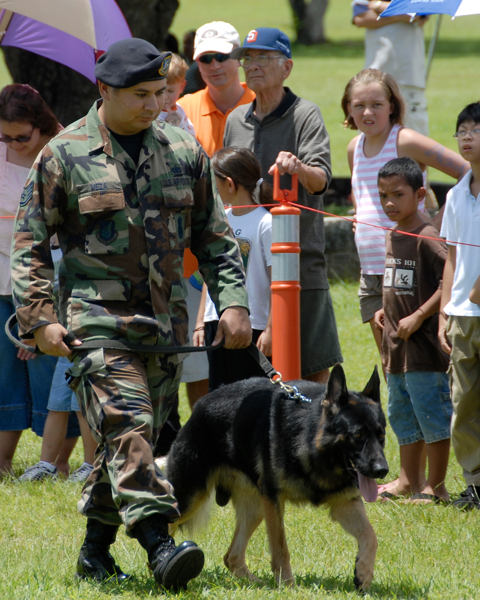 ANDERSEN AIR FORCE BASE GUAM, Staff Sgt. Joe Meza, a 36th Security Forces Squadron K9 handler, walks the perimeter of the K9 exhibition during the Air Force Week's demonstration at Ypao Beach Park Sept. 8. (U.S. Air Force Photo by Airman First Class Daniel Owen)