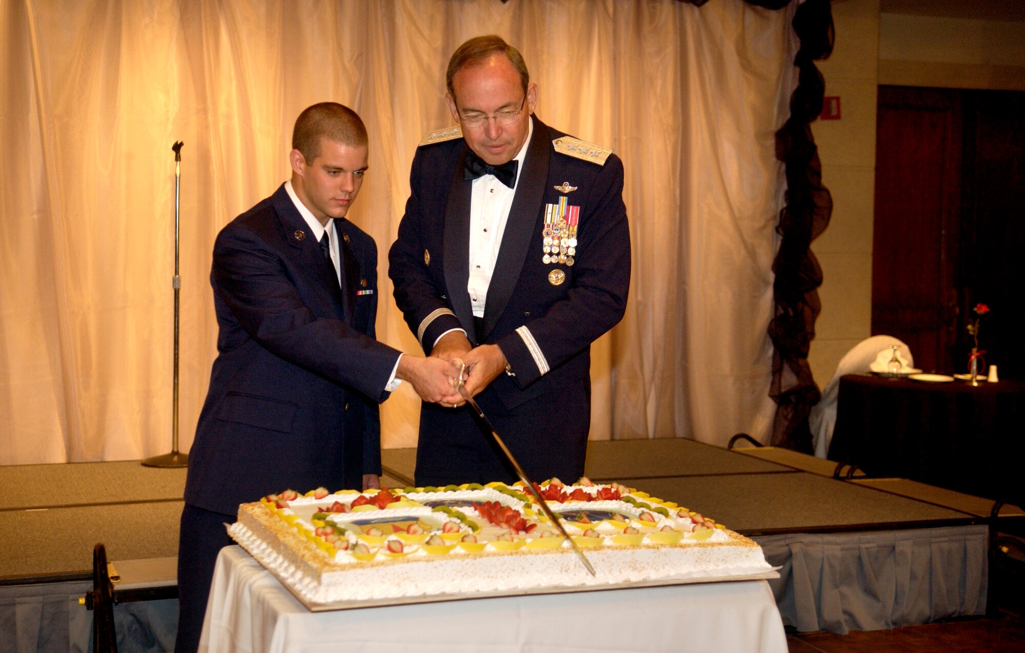 ANDERSEN AFB, GUAM -- Guest speaker, Lt. Gen. David Deptula, U.S.A.F. Deputy Chief of Staff for Intelligence, Surveillance and Reconnaissance, cuts the cake with the lowest ranking Airman in the room during the Air Force 60th Birthday Ball at Hilton Guam Resort on Sept. 8, 2007.  The ball was the final event of the Guam's Air Force Week. Air Force Week's purpose was to raise public awareness of the service's operations and capabilities, showcase its Airmen, and thank local citizens for their heartfelt support of its men and women over the Air Force's 60-year history. 
 (U.S. Air Force photo by Senior Airman Miranda Moorer/36th Wing Public Affairs )                                   