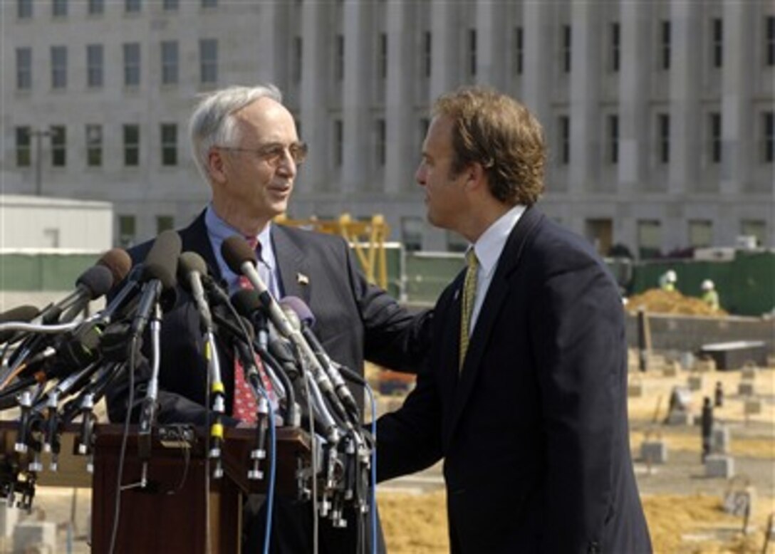 Deputy Secretary of Defense Gordon England (left) participates in a media event at the construction site of the Pentagon 9/11 memorial on Sept. 7, 2007.  England is welcomed to the lectern by President of the Pentagon Memorial Fund Jim Laychak whose brother was one of the 184 people killed in the 2001 terrorist attack.  