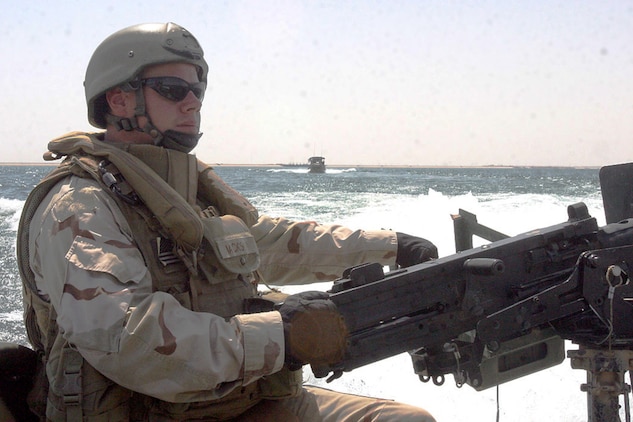 HADITHA DAM, Iraq, (Sept. 16, 2007) – Navy Petty Officer 1st Class Joshua L. Jackson, an aft (rear) gunner with Detachment 3, Riverine Squadron 1, Riverine Group 1, Navy Expeditionary Combat Command, in support of Regimental Combat Team 2, scans the waters during a curfew enforcement patrol on the Euphrates River near the dam. The regiment declared the temporary 24-hour curfew on the waterway to stem the suspected increase of enemy activity on the river during the Muslim holiday of Ramadan. Official Marine Corps Photo By Cpl. Ryan C. Heiser.