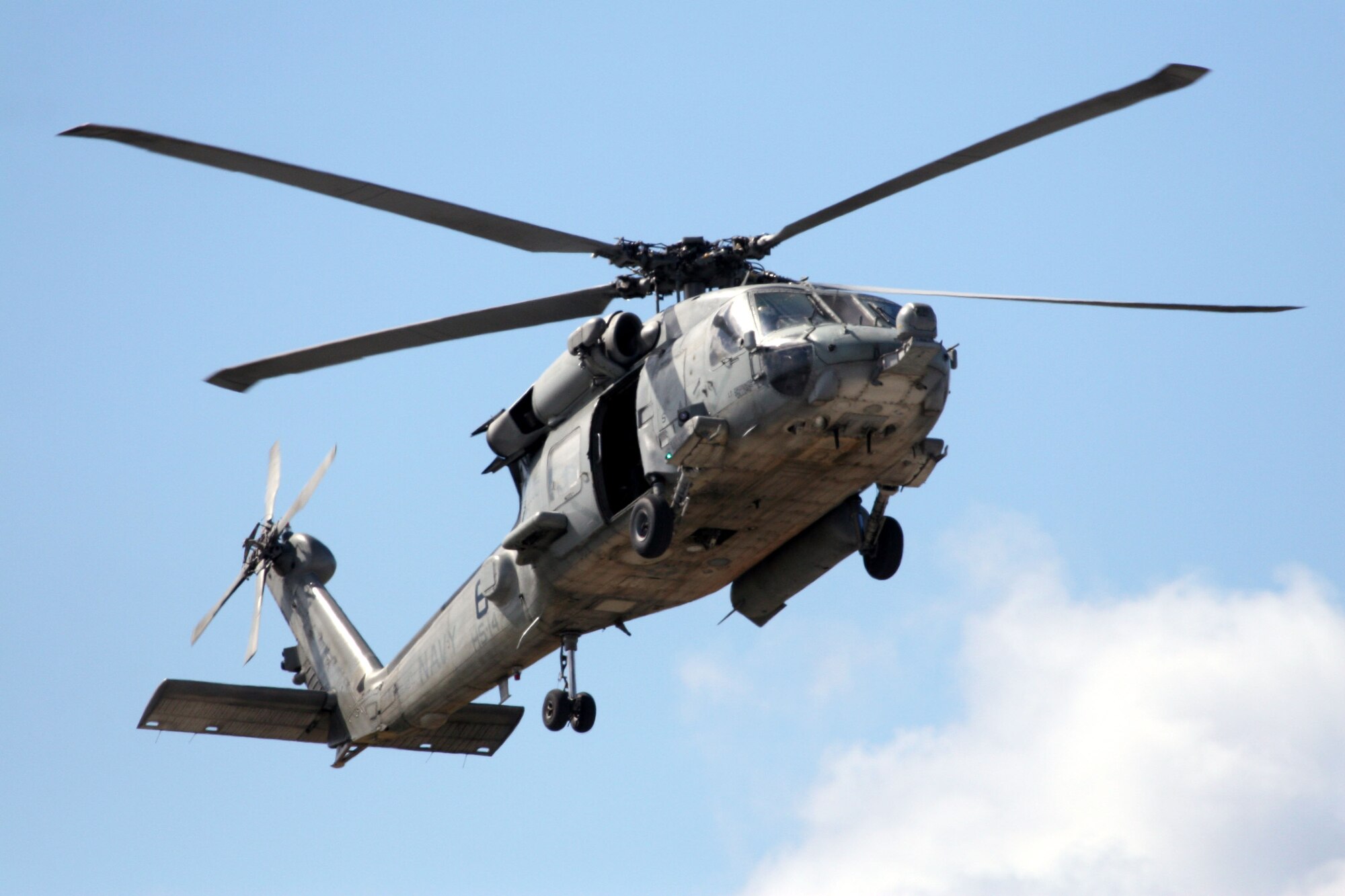 A Navy MH-60 Seahawk hovers over the jungle terrain of Guam. The MH-60 is ideally suited for combat search and rescue missions with its vertical take off and landing capability and was used here in joint exercises with Air Force aircraft and their aircrews. (Courtesy photo)