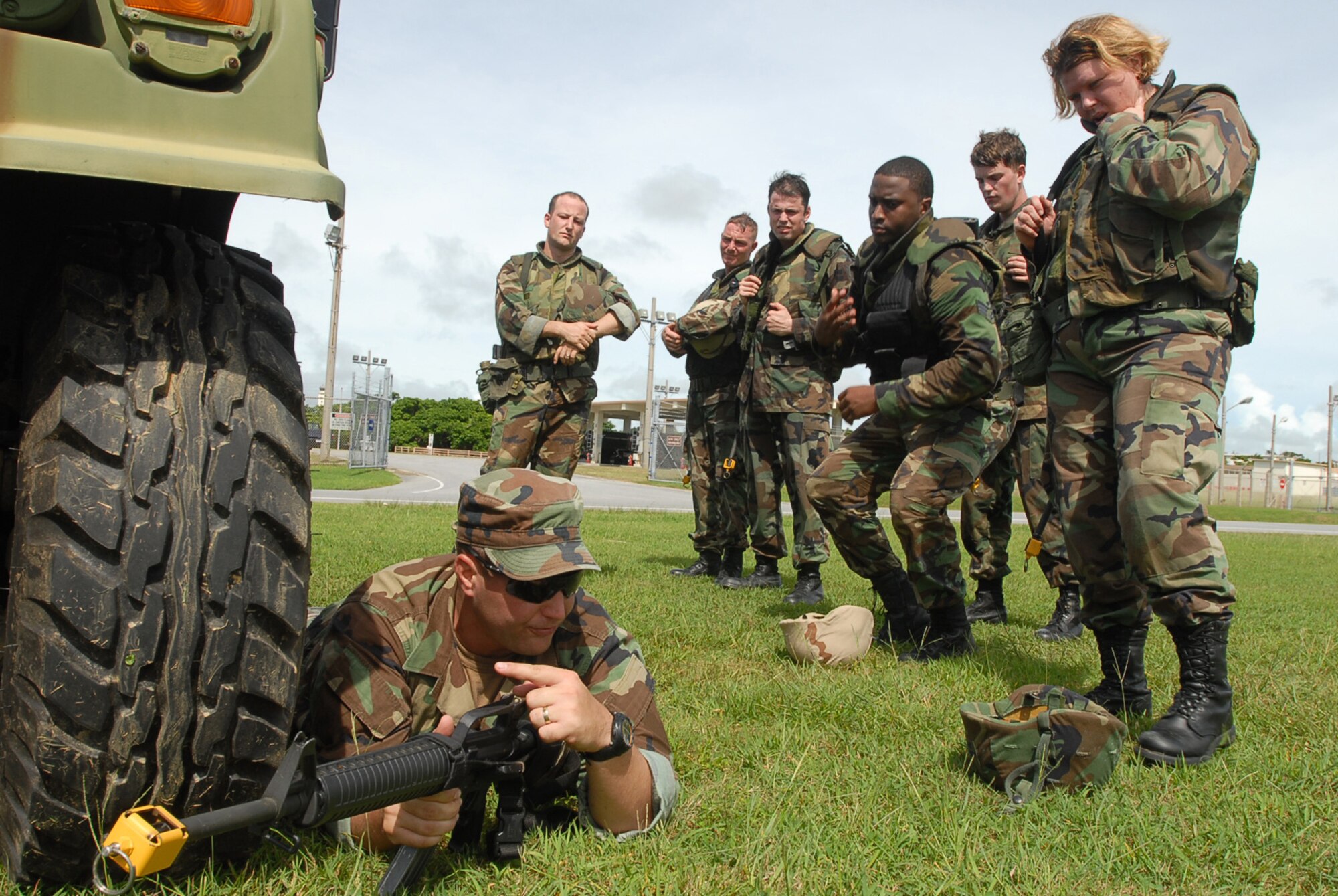 Staff Sgt. Adam Vargas explains to a group of Airmen the correct way to use a vehicle for cover during the Expeditionary Combat Skills Training at Kadena Air Base, Japan, Sept. 11, 2007. This course teaches the basic tools needed for surviving in the combat zone. Sergeant Vargas  is an 18th Wing Group ECST lead instructer assigned to  the 18th Logistics Readiness Sqaudron (U.S. Air Force Photo/Senior Airman Darnell T. Cannady)