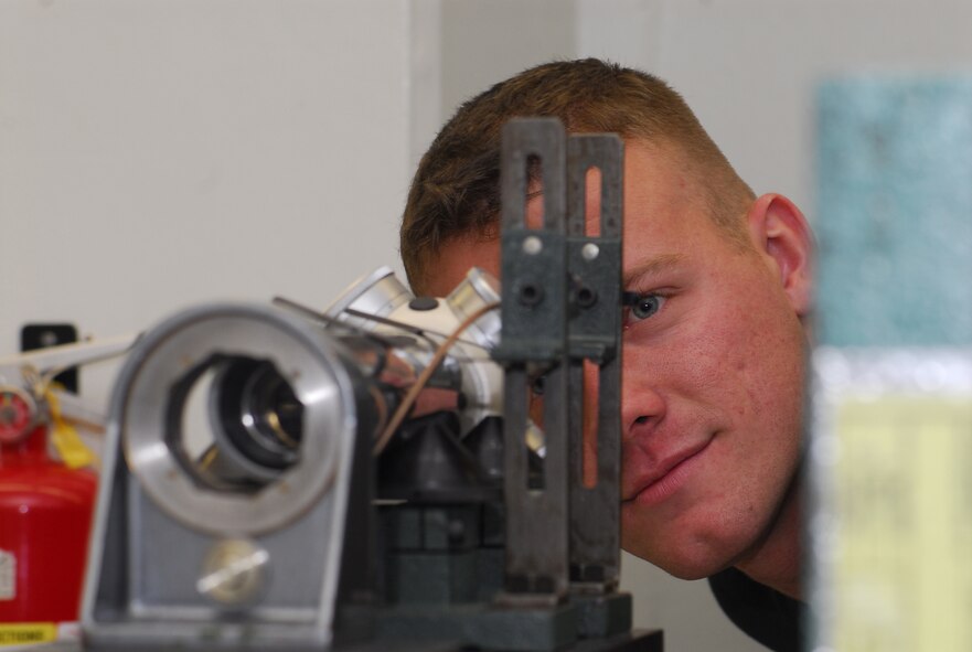 Staff Sgt. Christopher Corbine calibrates an alignment collimator making sure that the bore sight of the aircraft is aligned at Kadena Air Base, Japan, Sept. 11, 2007. The precision measurement equipment laboratory performs and manages repair, calibration, and modification of test, measurement, and diagnostic equipment standards and automatic test equipment. Sergeant Corbine is assigned to the 18th Component Maintenance Squadron. (U.S. Air Force photo/Airman 1st Class Sheila deVera)