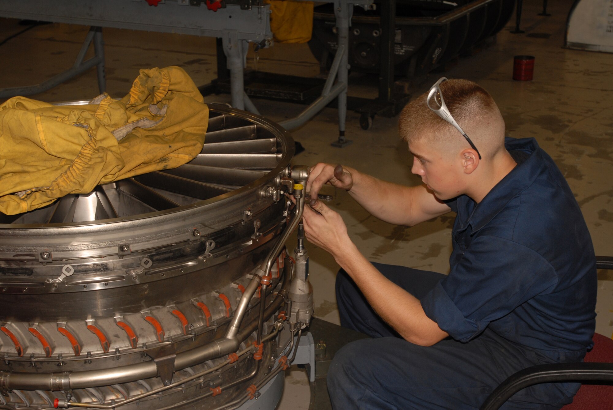 Airman 1st Class Aaron Chamberlain installs the inlet guide vane case on an F-15C F100-PW-220E engine at Kadena Air Base Sept. 11, 2007.  Airman Chamberlain works in the aerospace propulsion flight in the 18th Component Maintenance Squadron.  (U.S. Air Force photo/Airman 1st Class Ryan Ivacic)