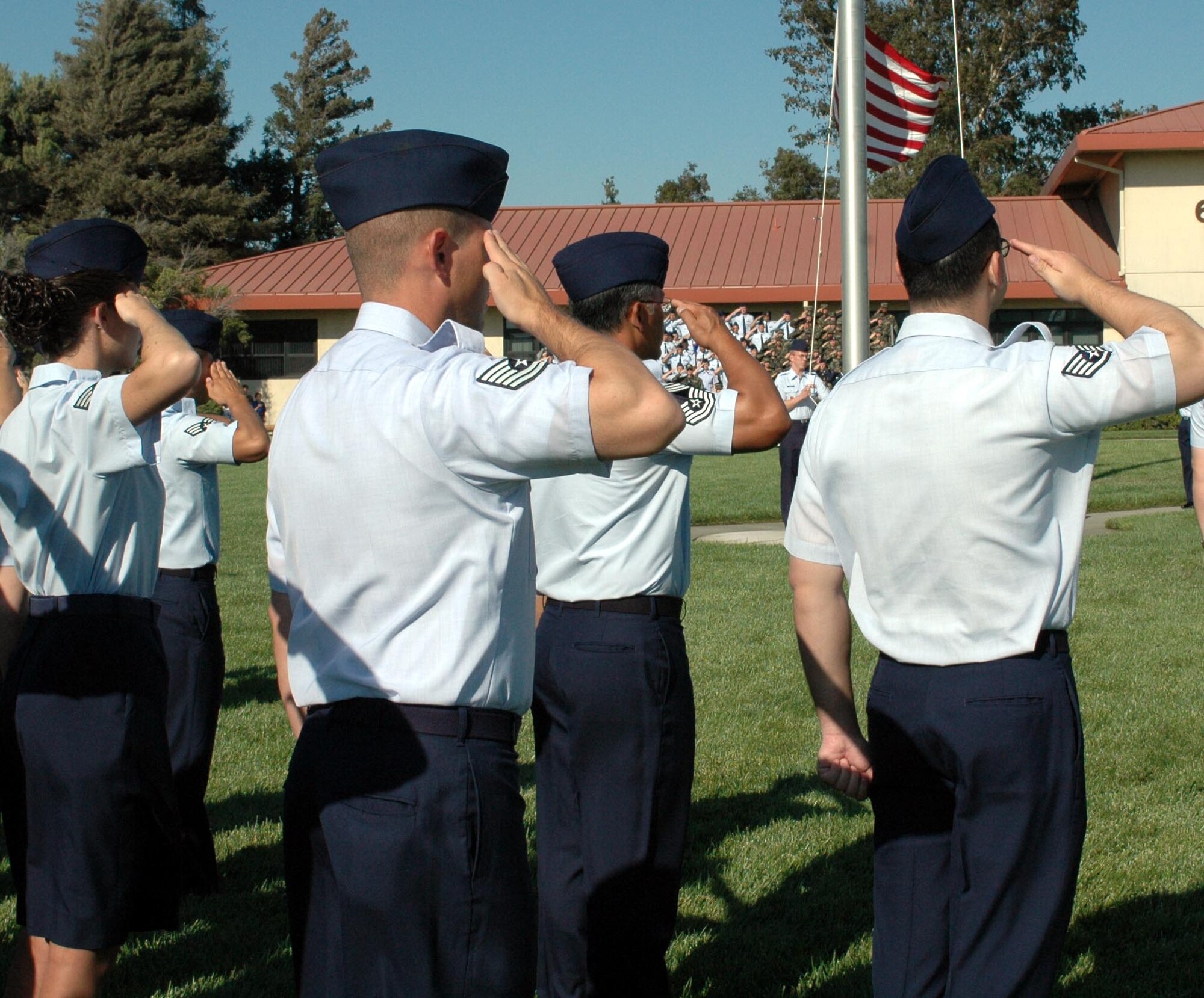 Airmen from the 60th Medical Group salute the colors during Team Travis' Sept. 11 Remembrance ceremony and retreat. Airmen from the 60th Operations, Mission Support, Maintenance Groups, Director of Staff, and the 615th Contingency Response Wing also participated in the ceremony. (U.S. Air Force photo/Staff Sgt. Candy Knight)