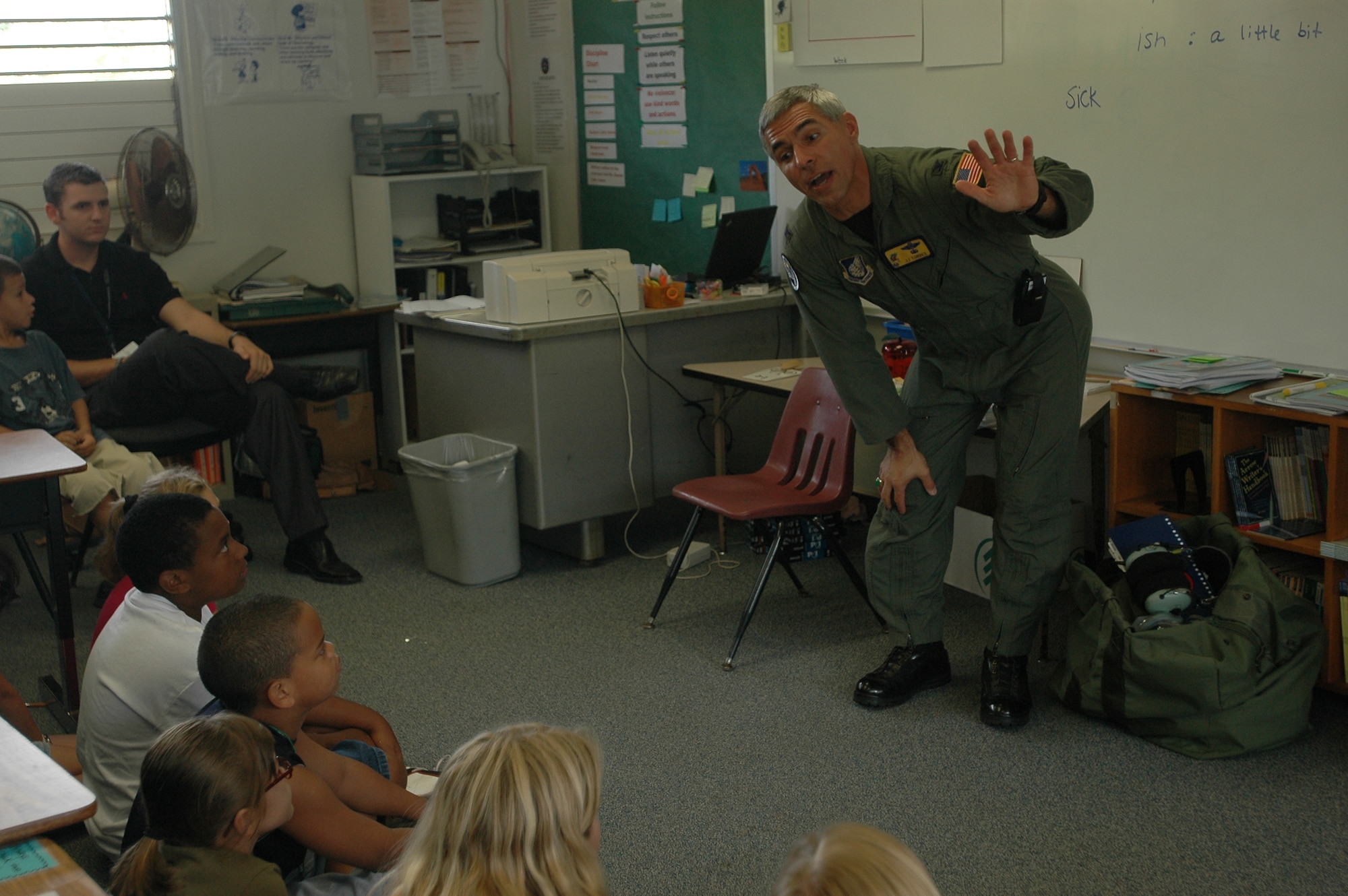 Col. J.J. Torres, 15th Airlift Wing commander, explains life in the Air Force to students at Hale Kula Elementary School, Schofield Army Barracks, Hawaii during Airmen in Education Day. Air Force members visited island schools during Airmen in Education Day, part of the Air Force Week Honolu celebration. Photo by 2nd Lt. Melanie McLean.