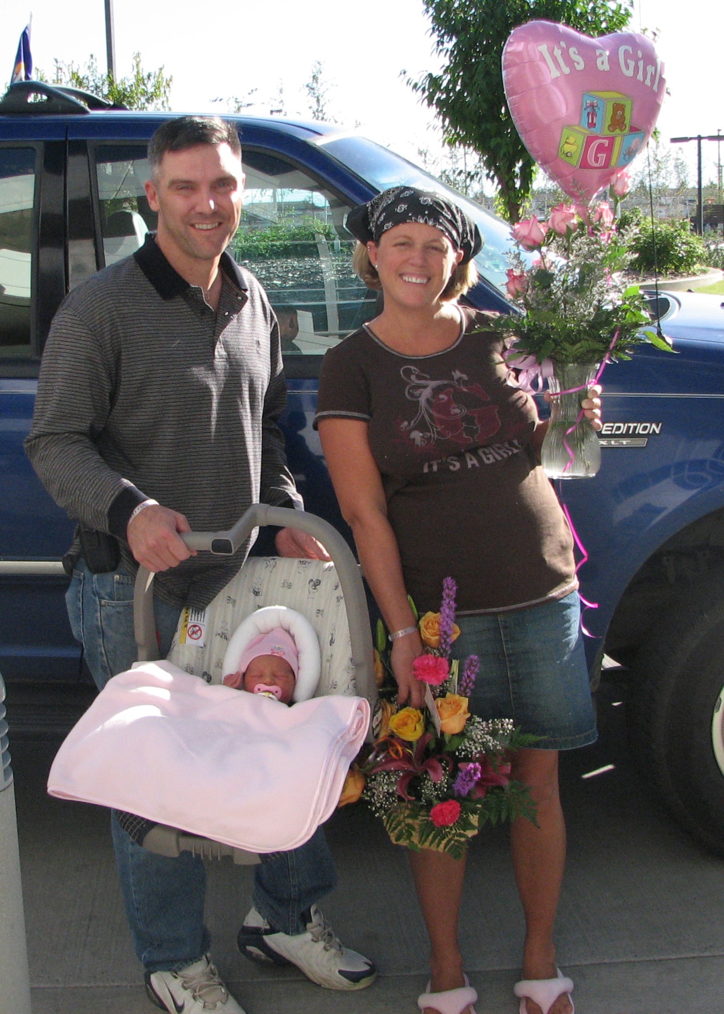EIELSON AIR FORCE BASE, Alaska--Maj. James O'Quinn, 354th Contracting Squadron commander, and wife, Lisa, pose for a photo with their new born Lillie. Mrs. O'Quinn self-delivered Lillie in her husband's truck on the way to the hospital during a labor that lasted less than 50 minutes. (courtesy photo)