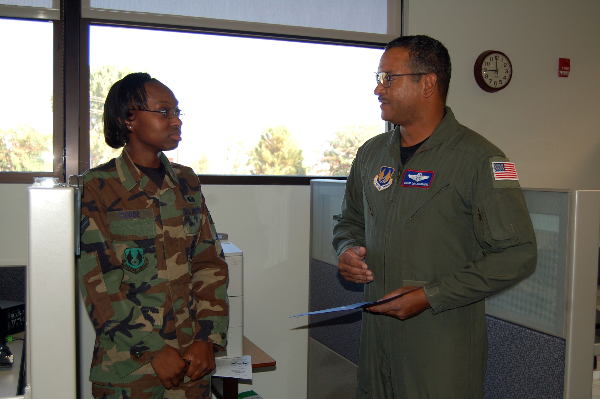 Chief Master Sgt. Luis Drummond (right), 412th Operations Group superintendent, congratulates Airman 1st Class Nancy Rouse (left), 95th Mission Support and Services Squadron evaluations technician, for receiving the Chief's Group's Dare to Soar award. The Dare to Soar award is presented to Airmen for their outstanding performance. Airman Rouse conducted base briefings on the new evaluation forms. (Photo by Airman 1st Class Julius Delos Reyes)