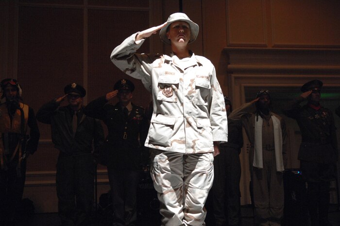 United States Air Force Tech. Sgt. Shelly Branch, a videographer assigned to the 99th Communications Squadron, renders a salute to the audience representing the future of Airmen during the past and present of the Air Force vignette display at the 60th Anniversary Air Force Ball September 8, 2007 at the Mirage Hotel and Casino Las Vegas, NV.
(U.S. Air Force photo by Senior Airman Larry E. Reid Jr.)