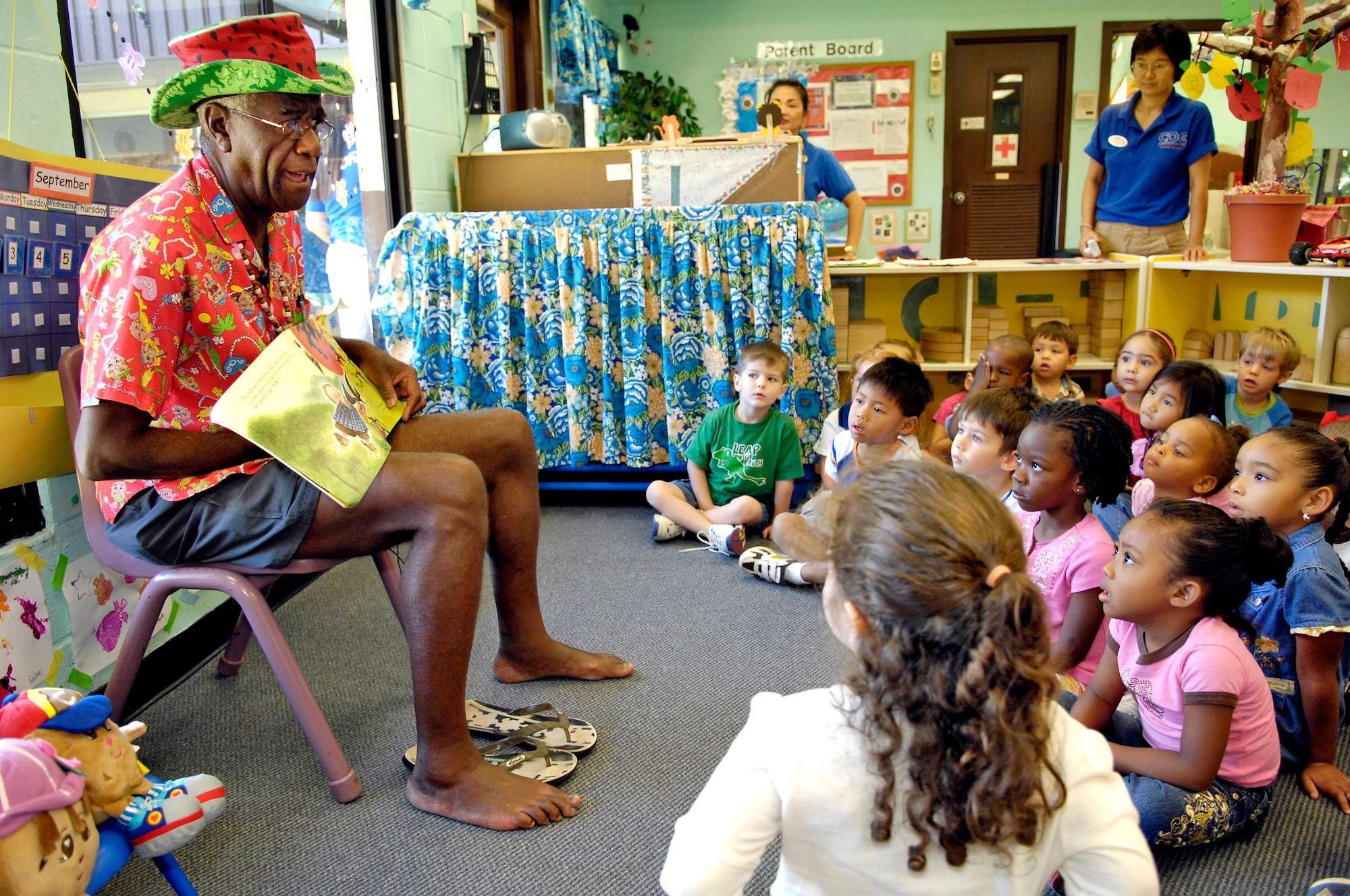 Wally Amos reads a story to children at the Child Development Center Sept. 10 at Hickam Air Force Base, Hawaii. Mr. Amos is an actor, writer and original entrepreneur behind the Famous Amos cookie brand. He is an advocate of literacy and early childhood development, and served in the Air Force four years. He read to children as part of Air Force Week Honolulu. (U.S. Air Force photo/Tech. Sgt. Shane A. Cuomo) 
