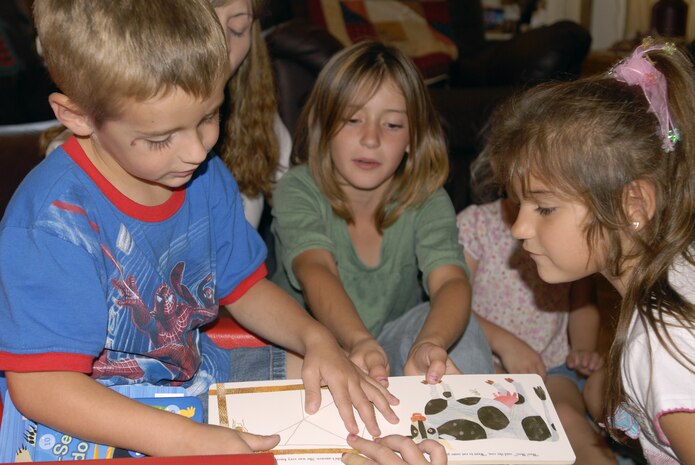 VADNENBERG AIR FORCE BASE, Calif. -- Sean Pitts interacts with the other children during a reading session on Sept. 6, at the home of his mother, Windy Pitts. Mrs. Pitts, who was recently named the 2007 Family Child Care Provider of the Year for Vandenberg, runs a full spectrum day care program from her home.  Her program includes school fundamentals, arts and crafts, and field trips for the six children in her care. (U.S. Air Force photo/Airman 1st Class Ashley Reed)