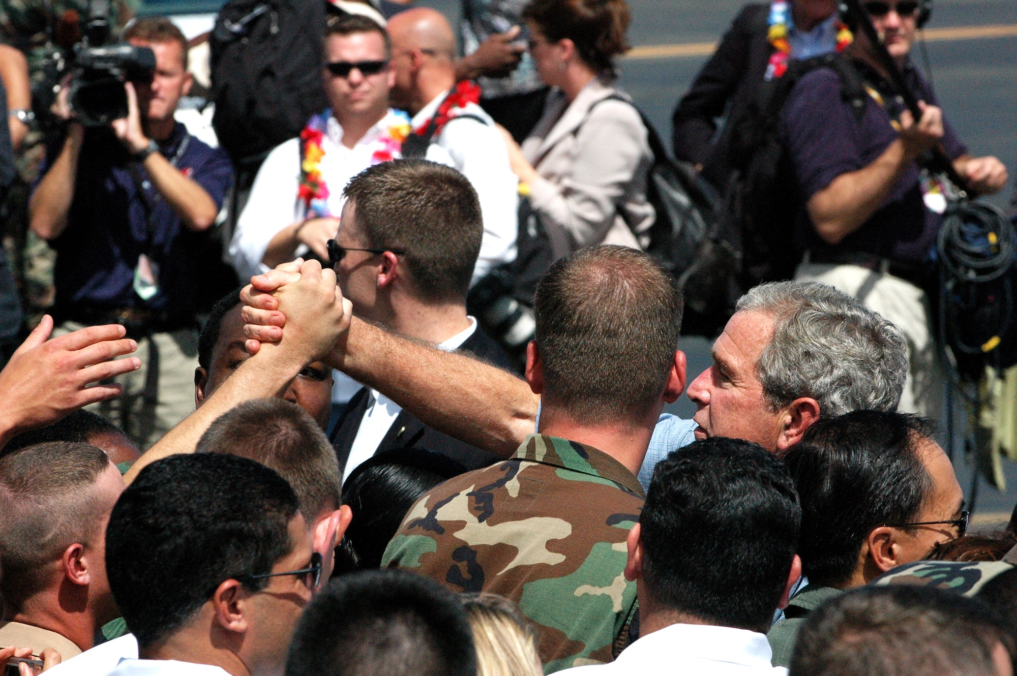 President George W. Bush exits Air Force One at Hickam AFB during his visit to Hawaii, Sept. 8. The president met with 33 wounded servicemembers and their families and presented Caroline Tom with a volunteer service pin for 15 years of donating her time. (U.S. Air Force photo/2nd Lt. Melanie McLean)
