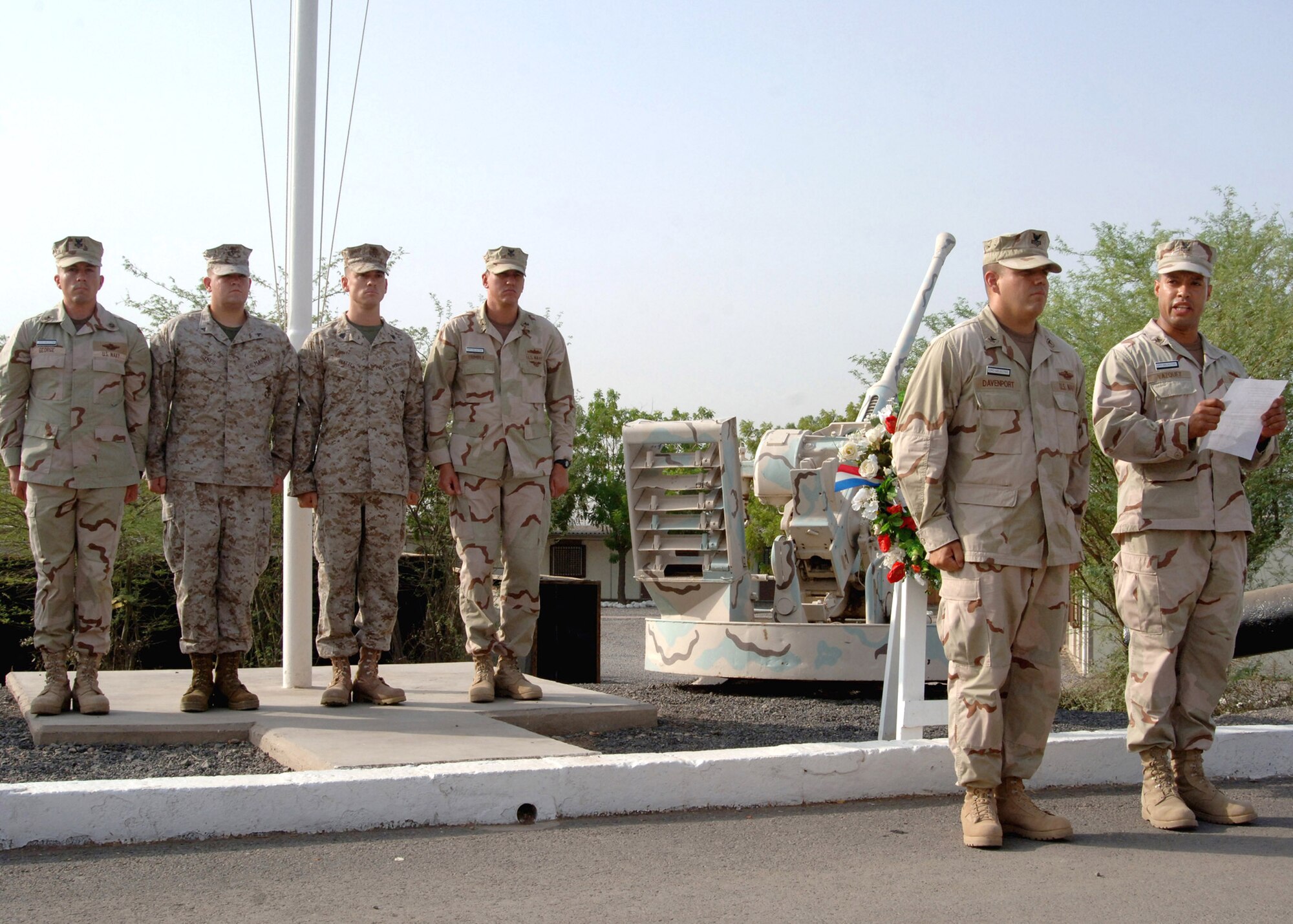 Members of the color guard stand at attention as Navy Petty Officer 1st Class Arcenet Vazquez speaks after presenting a wreath in remembrance of the sixth anniversary of Sept. 11. The presentation was one of several events at Camp Lemonier, Djibouti, sponsored by Combined Joint Task Force-Horn of Africa 2008 Navy chief selectees. (U.S. Navy photo/Petty Officer 2nd Class Regina L. Brown)
