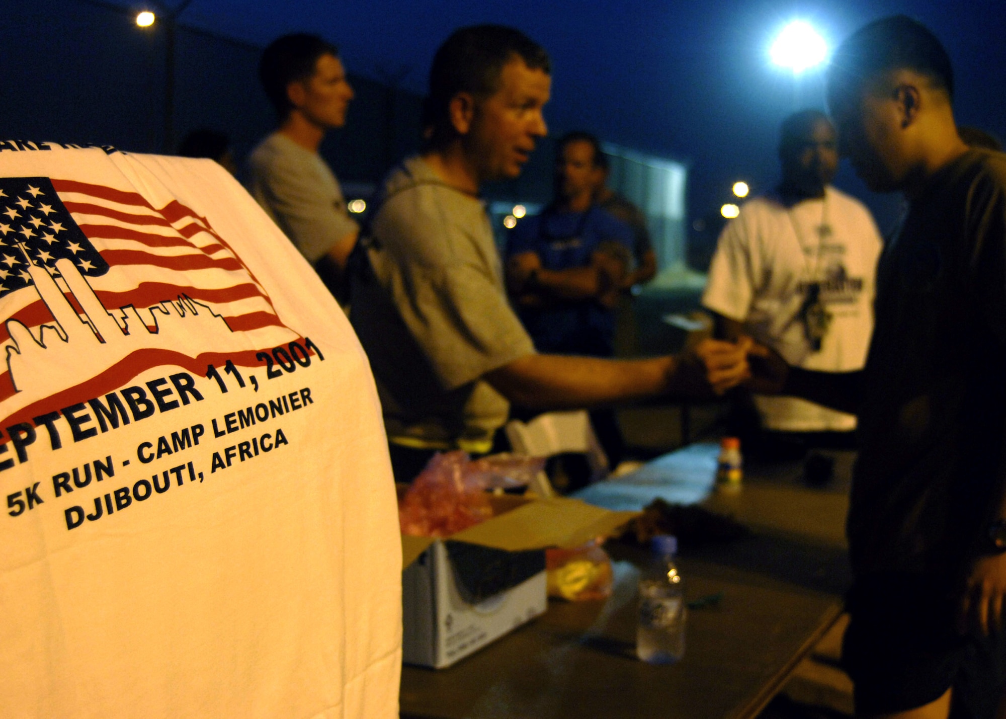 Navy Petty Officer 1st Class Brent Arntzen registers runners for the Sept. 11 remembrance 5K run Sept. 11 at Camp Lemonier, Djibouti. The run kicked off a day of remembrance events on Camp Lemonier sponsored by the Combined Joint Task Force-Horn of Africa 2008 Navy chief selectees. (U.S. Navy photo/Petty Officer 2nd Class Regina L. Brown)
