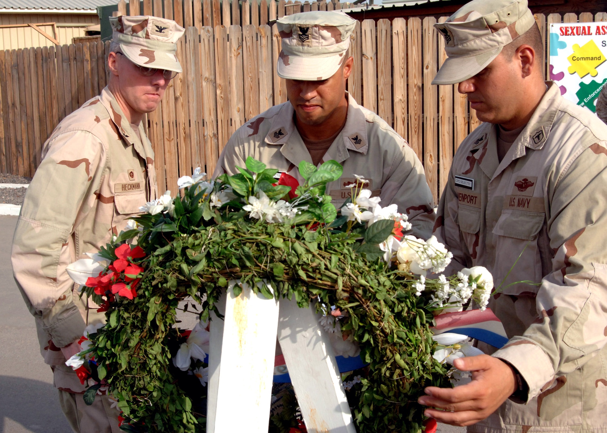 (From left) Capt. John Heckmann, Navy Petty Officer 1st Class Arcenet Vazquez and Navy Petty Officer 1st Class Eric Davenport present a wreath in remembrance of the sixth anniversary of Sept. 11 at Camp Lemonier, Djibouti. The wreath presentation was one of the events sponsored by the Combined Joint Task Force-Horn of Africa 2008 Navy chief selectees. Captain Heckmann is the Camp Lemonier commanding officer. (U.S. Navy photo/Petty Officer 2nd Class Regina L. Brown)

