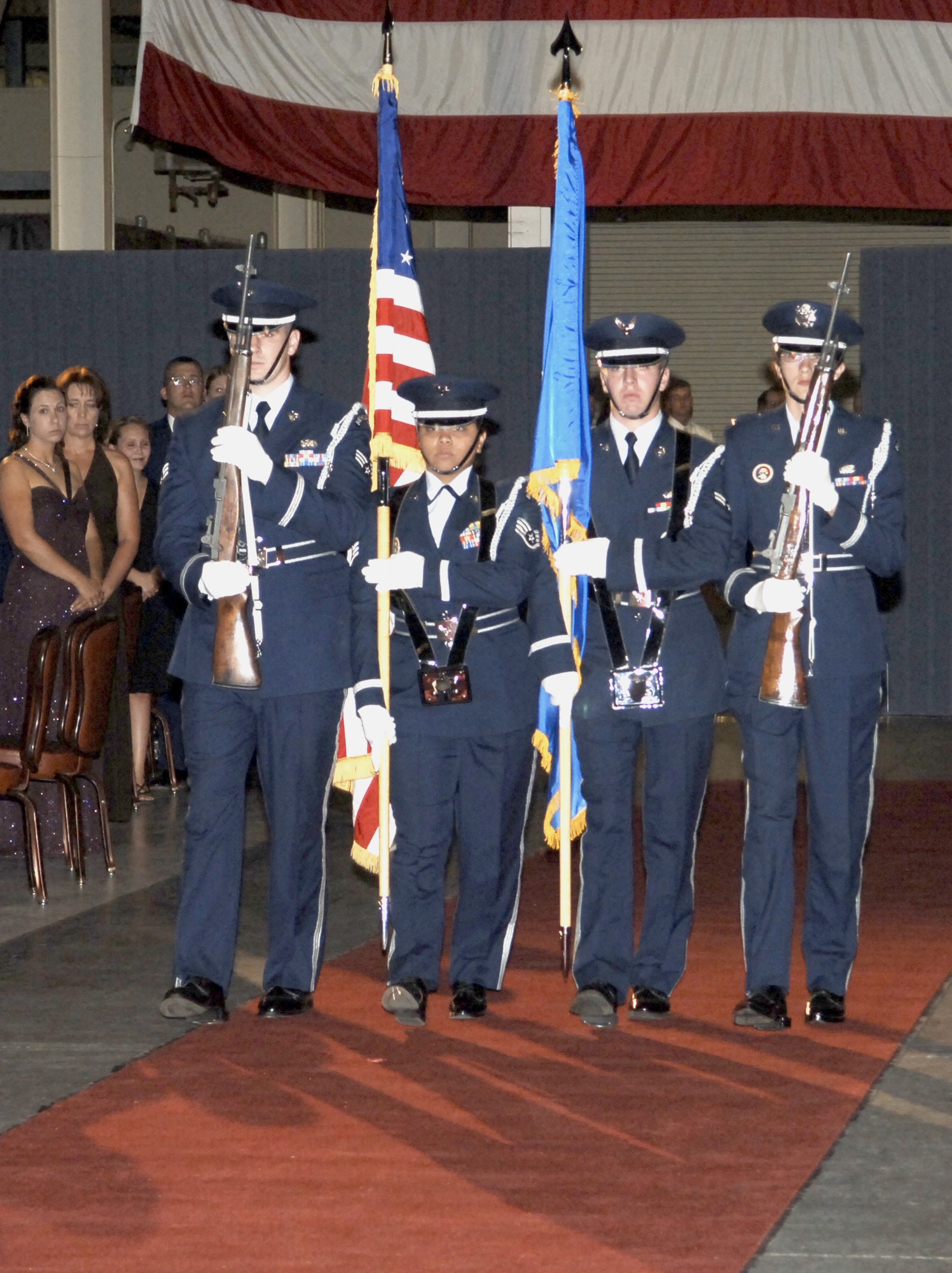 FAIRCHILD AIR FORCE BASE, Wash. – Members of the Fairchild Honor Guard team march down the red carpet at the 2007 Air Force Ball to post the colors for the singing of the National Anthem, performed by Staff Sergeants Rori Ross and Joshua Jones and Chaplain (Lt. Col.) Jeffrey Neuberger. More than 700 guests attended the ball Sept. 8, held in commemoration of the 60th Anniversary of the Air Force. (U.S. Air Force photo / Senior Airman Chad Watkins)
