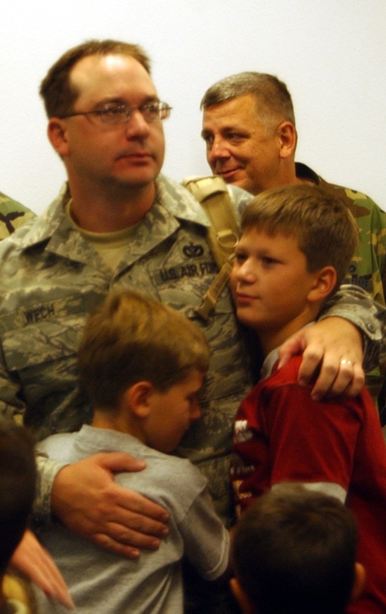 Tech. Sgt. Scott Wech hugs his boys before departing building 3080 Sept. 11 with the rest of his 819th RED HORSE Squadron counterparts. Nearly 200 members of the squadron deployed for a six-month tour to eight locations in southwest Asia in support of the Global War on Terrorism. (U.S. Air Force photo/Valerie Mullett)                      