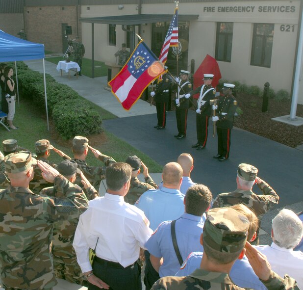 Airmen and civilians render proper respects to the colors as the National Anthem plays during a remembrance ceremony Sept. 11. (U.S. Air Force photo by Senior Airman Angelita Lawrence)