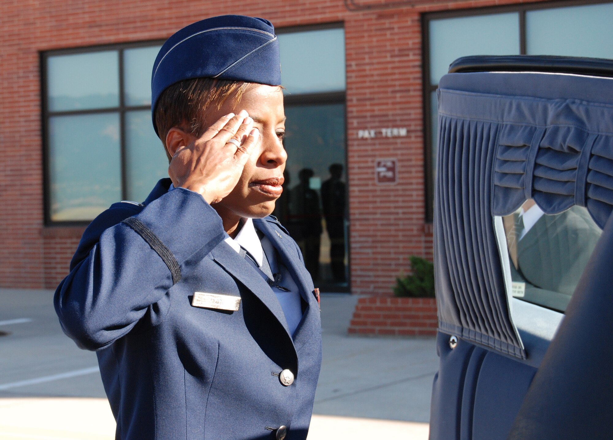 PETERSON AFB, Colo. -- Capt. Carla Sizer, U.S. Air Force Academy Department of Management, renders a salute to her son, Pfc. Dane Belcon, who was killed Sept. 5 in support of Operation Iraqi Freedom. Private Belcon’s casket arrived at Peterson Sept. 11. He was assigned to the 1st Squadron, 7th Cavalry Regiment, 3rd Brigade Combat Team, 1st Cavalry Division, Fort Hood, Texas.
Captain Sizer remembered her son’s dedication to duty citing “his dream was to serve his country well; he was willing to die for his country.” Although he was in the Army, he also held himself to Air Force core values, she added. “When he spoke to USAFA cadets, he would encourage them to step up. Even in high school, he had the highest standards and believed military standards are the foundation of what we do.” (U.S. Air Force photo by Tech. Sgt. Matt Gilreath)