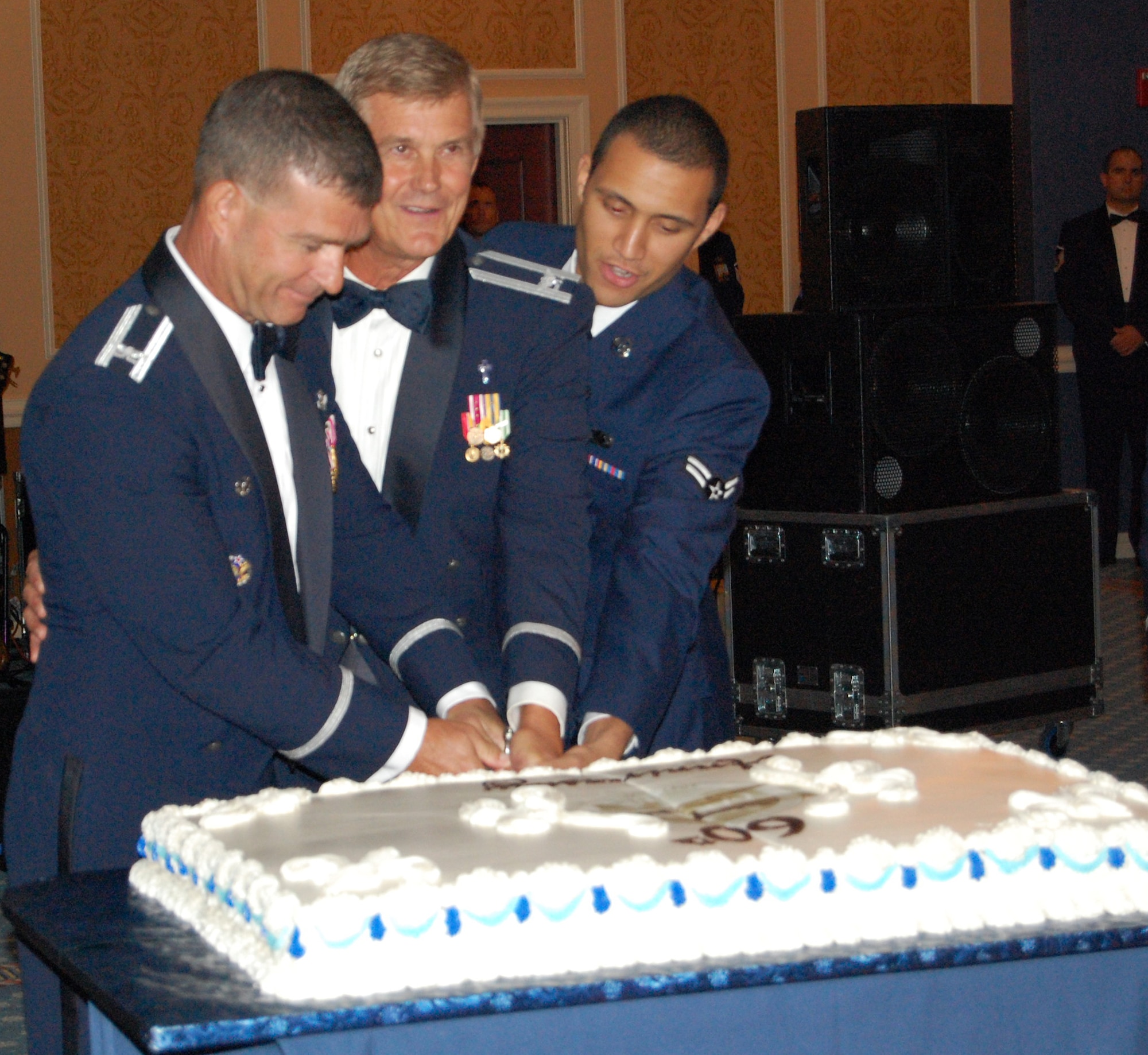 Col. Mark Barrett, 1st Fighter Wing commander, Chaplain (Col.) Dwight Braswell, 1st FW, and Airman Jade Pina, 1st Comptroller Squadron, cut the cake during the Air Force Gala at the Bayside Enlisted Club, Sept. 7. More than 400 Airmen participated in the night’s festivities, which included food, music and dancing. (U.S. Air Force photo/Airman 1st Class Chase S. DeMayo)
