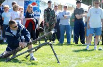 Maj. David Williams, 90th Security Support Squadron commander, launches a buffalo chip more than two hundred feet. Major Williams received 1st place in the event Aug. 24 during Frontiercade (Photo by Airman 1st Class Daryl Knee).