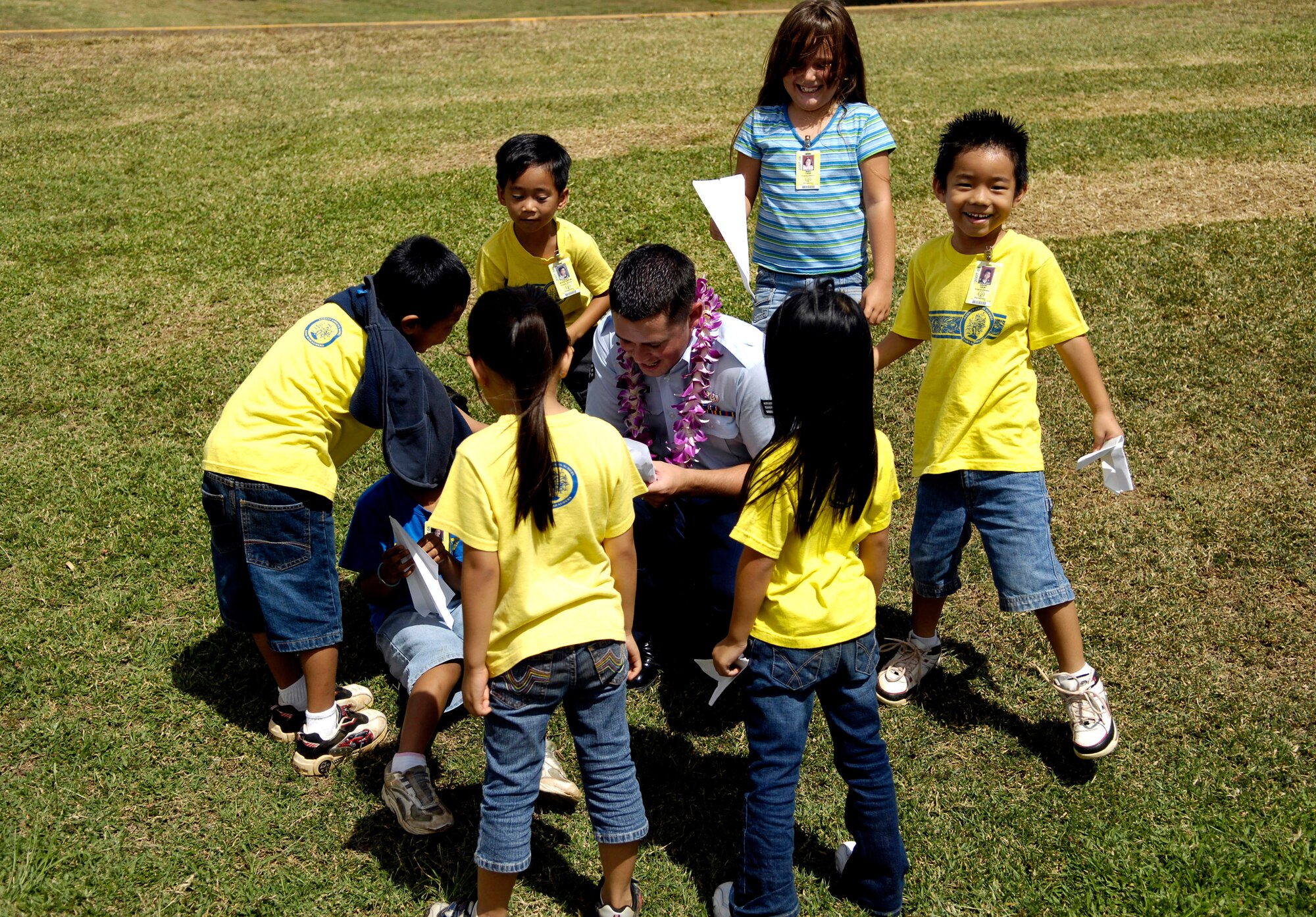 Senior Airman Robert Bond helps children from August Ahrens Elementary School in Waipahu, Hawaii, make paper airplanes Sept. 10 during Air Force Week Honolulu. Approximately 800 Airmen from Hickam Air Force Base, Hawaii, spent their day at 80 local schools on the island of Oahu reading, playing and educating children about the Air Force. Airman Bond is from the 15th Airlift Wing Services Squadron. (U.S. Air Force photo/Tech. Sgt. Shane A. Cuomo) 
