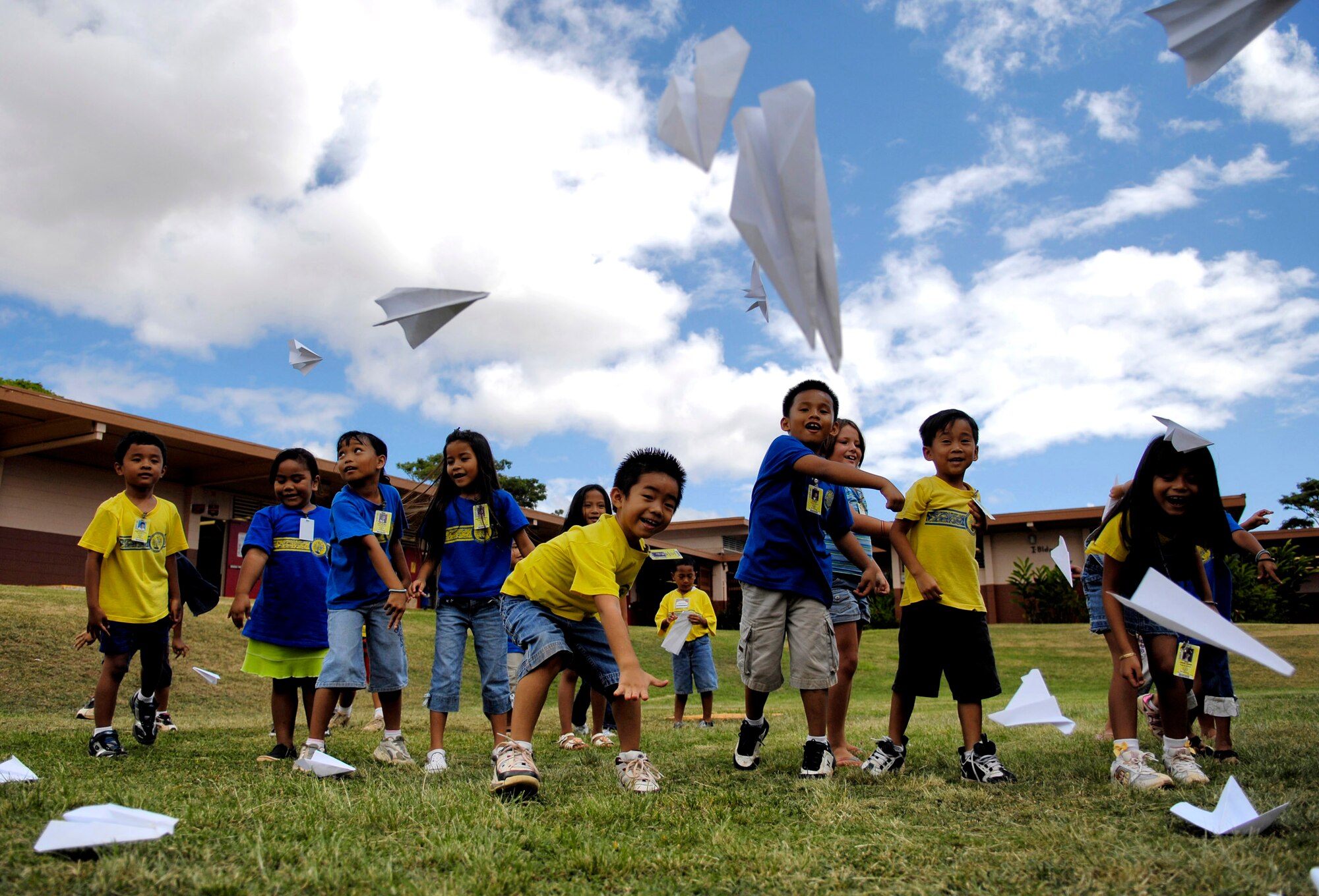 Children from August Ahrens Elementary School in Waipahu, Hawaii, throw paper airplanes Sept. 10 during Air Force Week Honolulu. Approximately 800 Airmen from Hickam Air Force Base, Hawaii, spent their day at 80 local schools on the island of Oahu reading, playing and educating children about the Air Force. (U.S. Air Force photo/Tech. Sgt. Shane A. Cuomo) 
