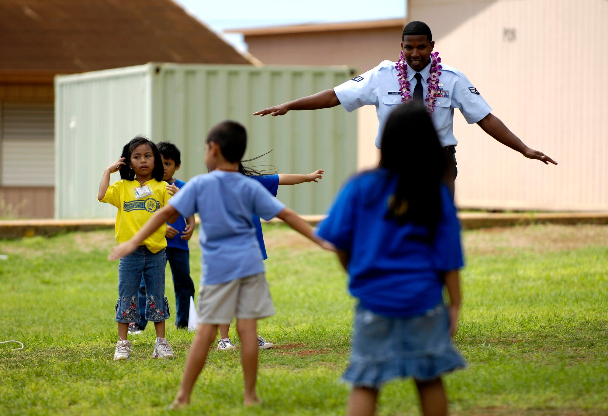 Senior Airman Andrew William plays with children from August Ahrens Elementary School in Waipahu, Hawaii Sept. 10 during Air Force Week Honolulu. Approximately 800 Airmen from Hickam Air Force Base, Hawaii, spent their day at 80 local schools on the island of Oahu reading, playing and educating children about the Air Force. Airman William is with the 15th Civil Engineer Squadron. (U.S. Air Force photo/Tech. Sgt. Shane A. Cuomo) 
