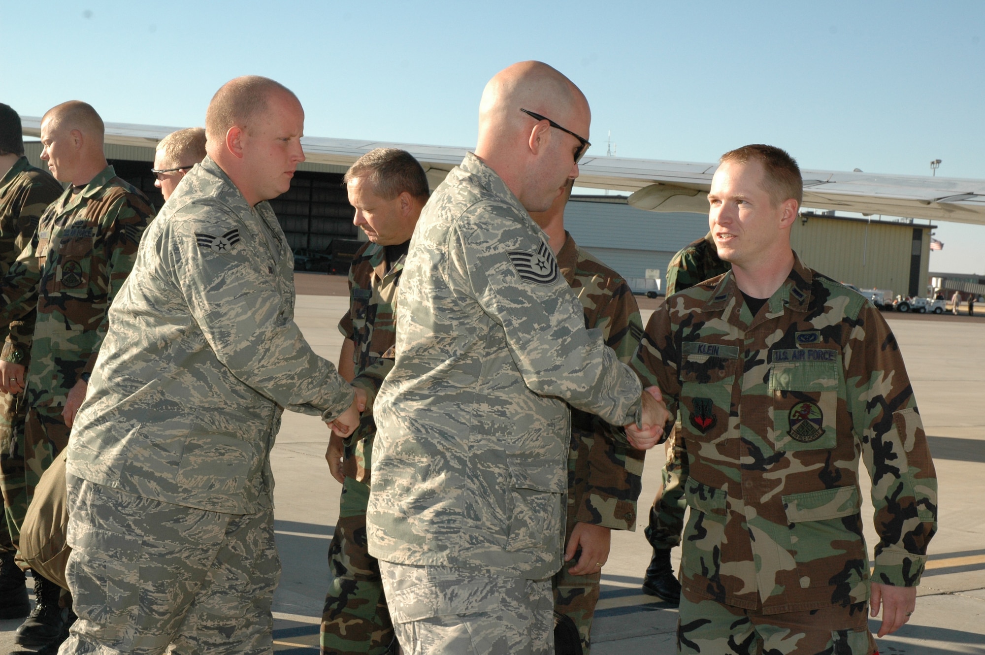 First Lt. Jeff Klein, 819th RED HORSE Squadron, shakes hands with a member of the 819th RHS who deployed Sept. 11 in support of the Global War on Terrorism. Nearly 200 members of the 819th RHS will be serving in this deployment to southwest Asia. (U.S. Air Force photo / Airman 1st Class Emerald Ralston)