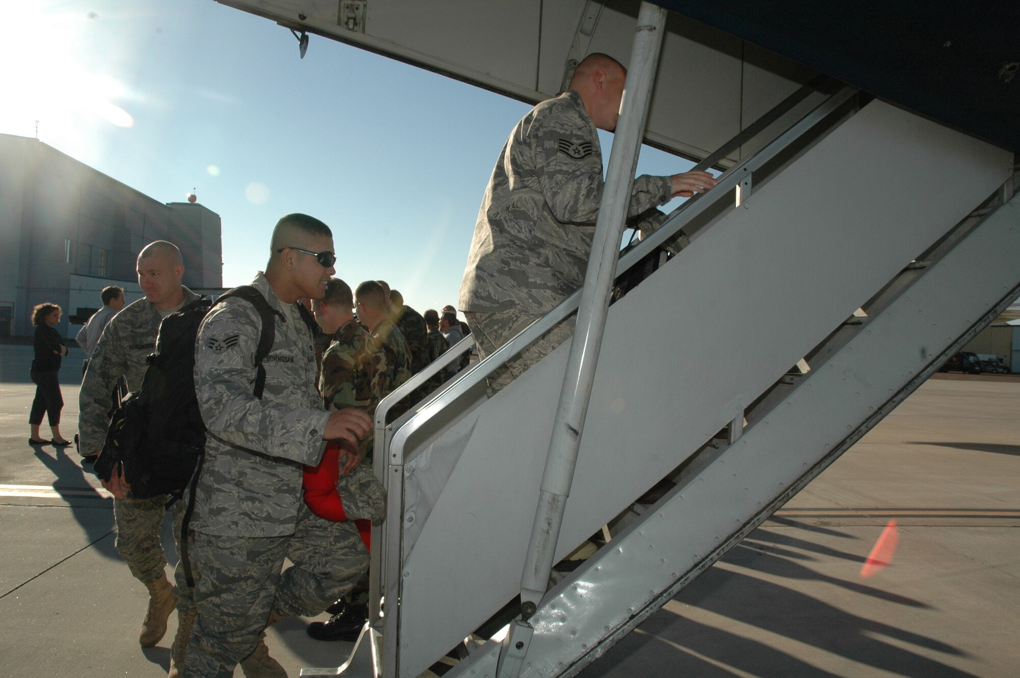 Members of Malmstrom's 819th RED HORSE Squadron board a plane Sept. 11 as they prepare to deploy to Southwest Asia in support of the Global War on Terrorism. Nearly 200 members of the 819th RHS will be serving in this deployment. (U.S. Air Force photo / Airman 1st Class Emerald Ralston)