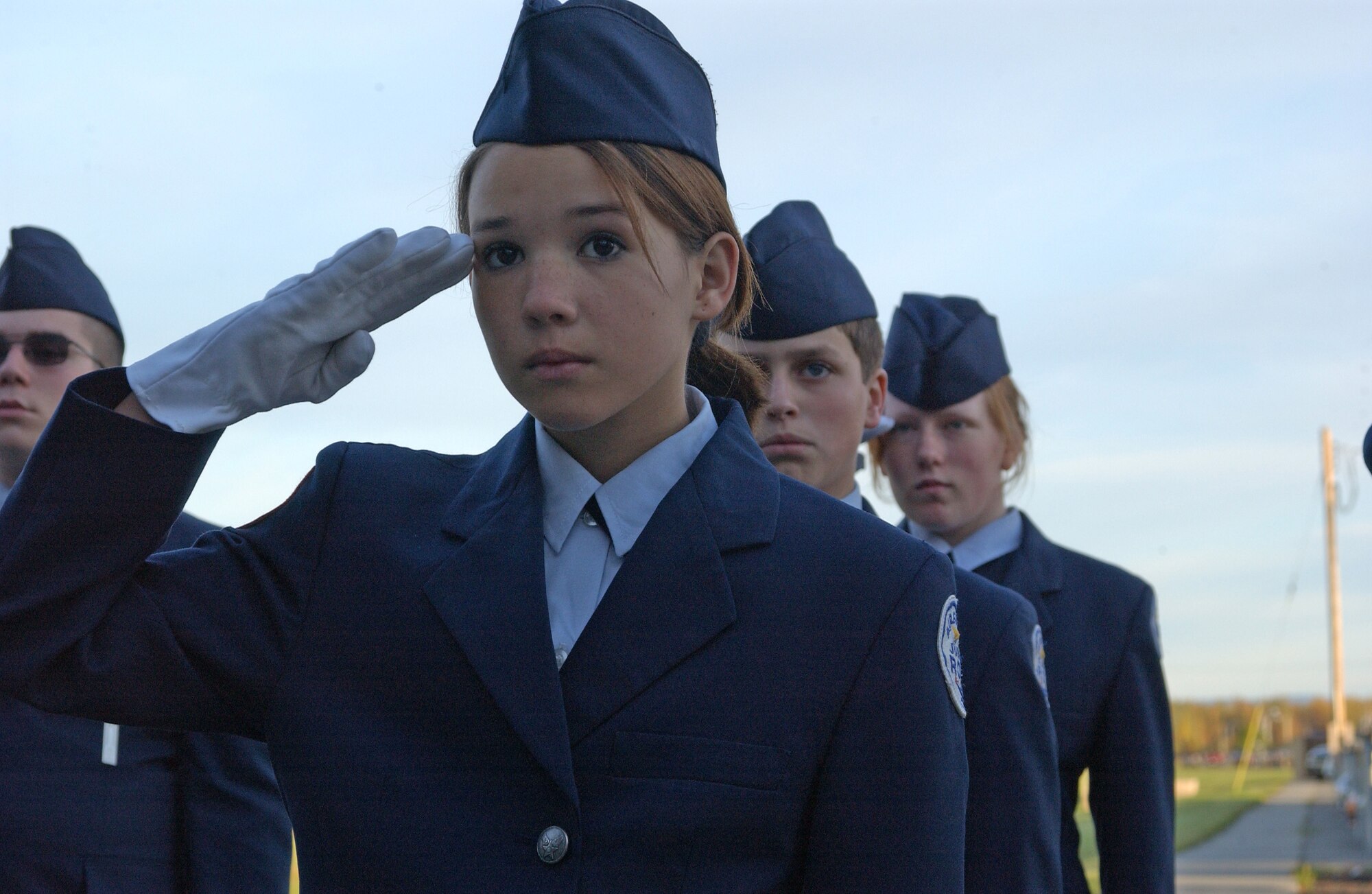 EIELSON AIR FORCE BASE, Alaska--Cadet Airman Basic Brittany Fife, Junior Ben Eielson Reserve Officer Training Corps, salutes the flag as it is being raised up the flag pole during the Sept. 11 reveille ceremony infront of Amber Hall. Ben Eielson JROTC cadets perform an annual reveille ceremony, this one highlighting the anniversary of the Sept. 11 attack on the U.S. (U.S. Air Force photo by Airman 1st Class Nora Anton)                                       