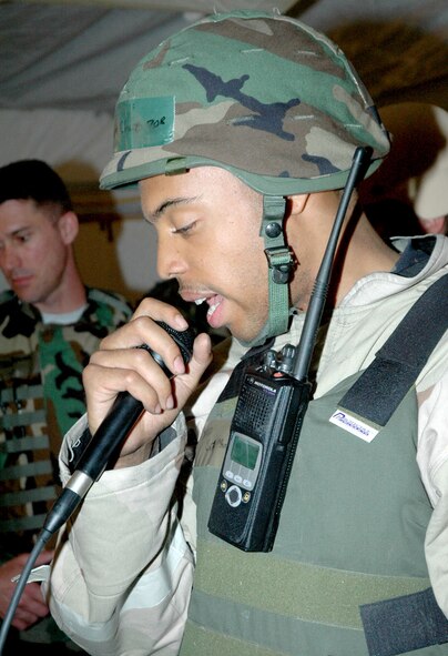 Senior Airman Chaz McCain, 90th Space Wing Command Post, broadcasts a message across the camp’s “giant voice” system to alert everyone in the camp during the exercise here Aug. 15 (Photo by Tech. Sgt. Dale Yates).