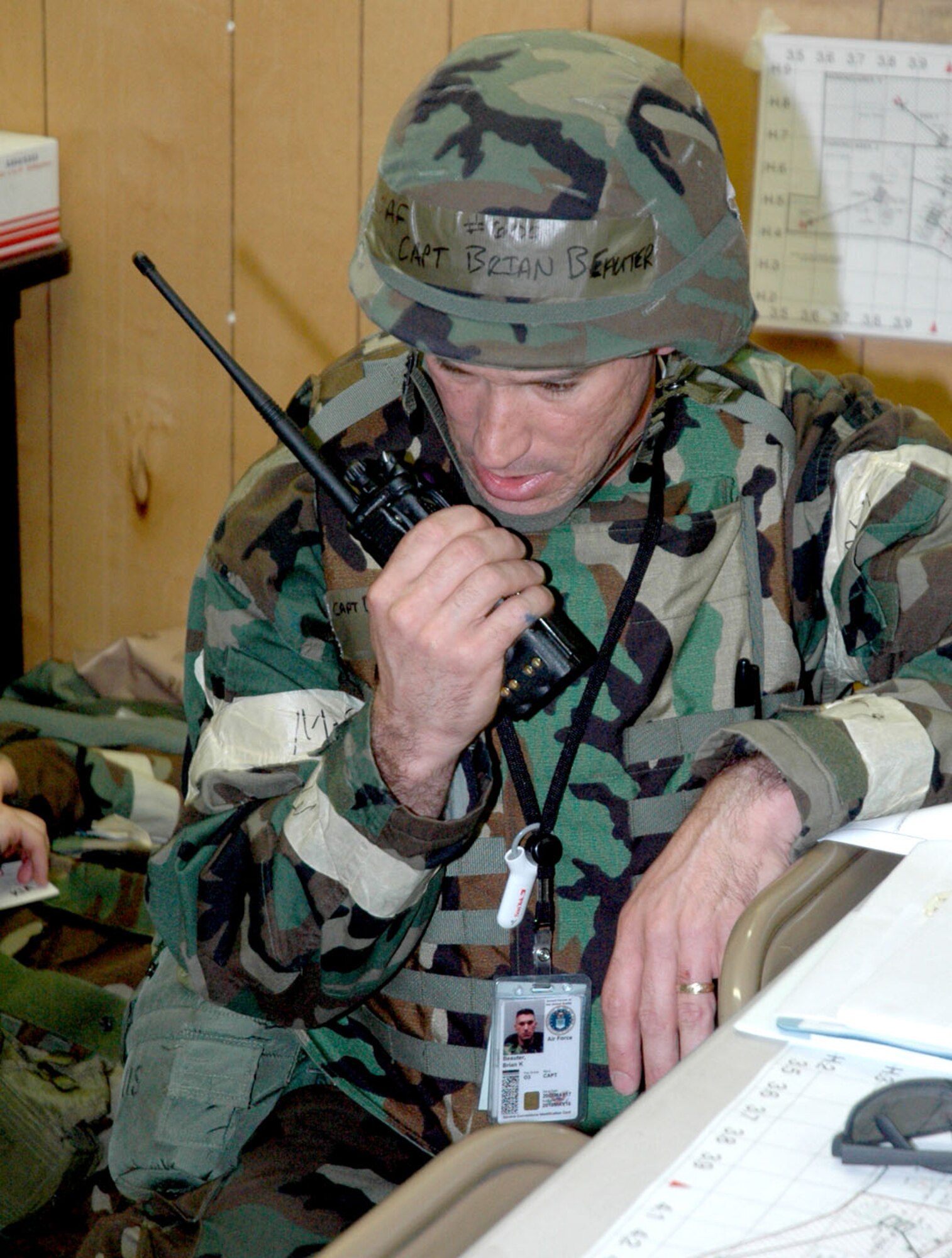 Capt. Brian Beauter, 90th Communications Squadron, assumes command and radios for the evacuation of the Emergency Operation Center to its alternate location during Field Warrior 07-03 here Aug. 15. Moments before a simulated mortar struck the facility leading to the simulated death of the camp’s commander, Lt. Col. Jonathan Webb (Photo by Tech. Sgt. Dale Yates).