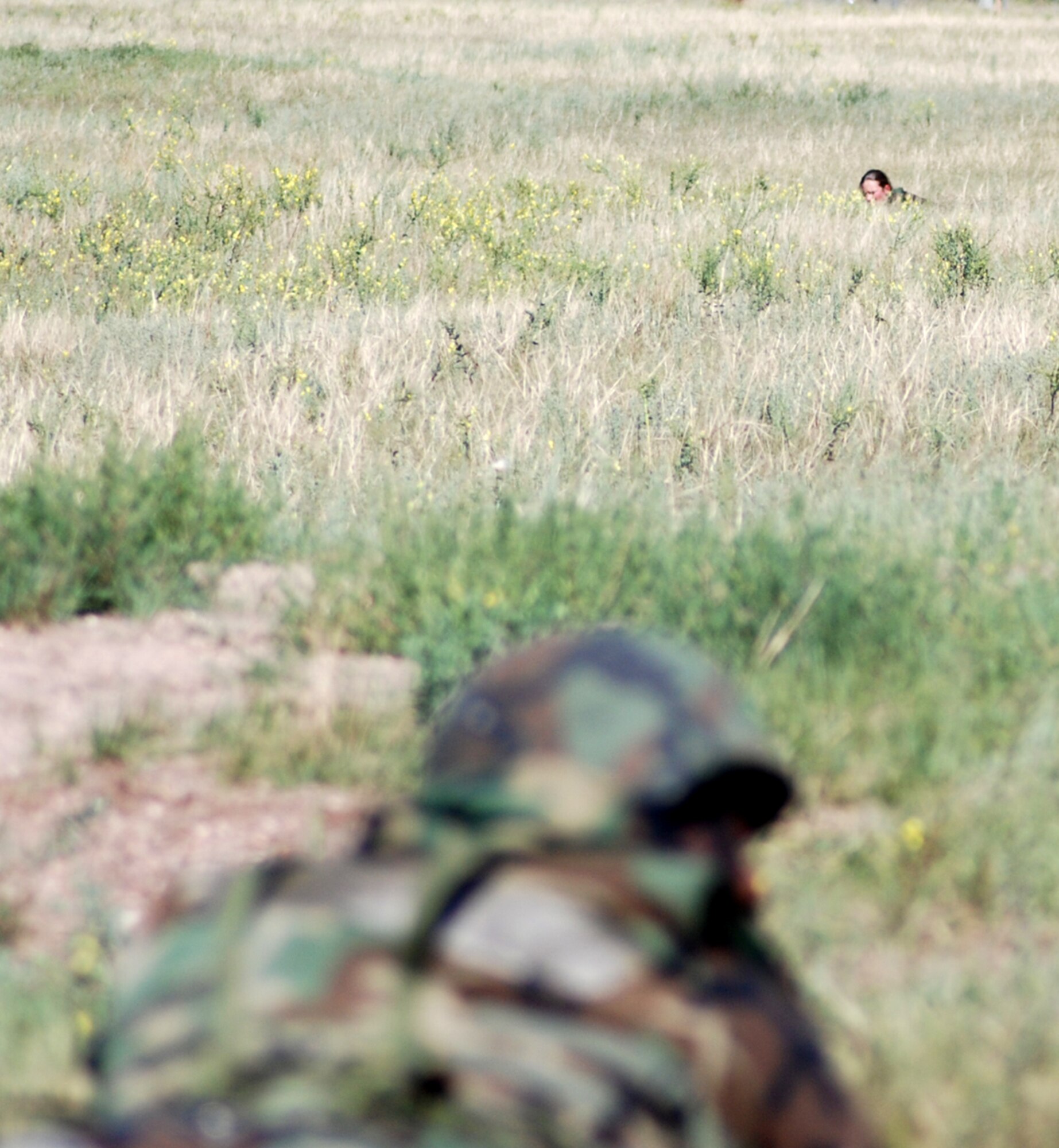 Tech. Sgt. Tad Marshall, 90th Maintenance Group, simulates shooting at enemy snipers during the Field Warrior exercise Aug. 17 (Photo by Airman Alex Martinez).