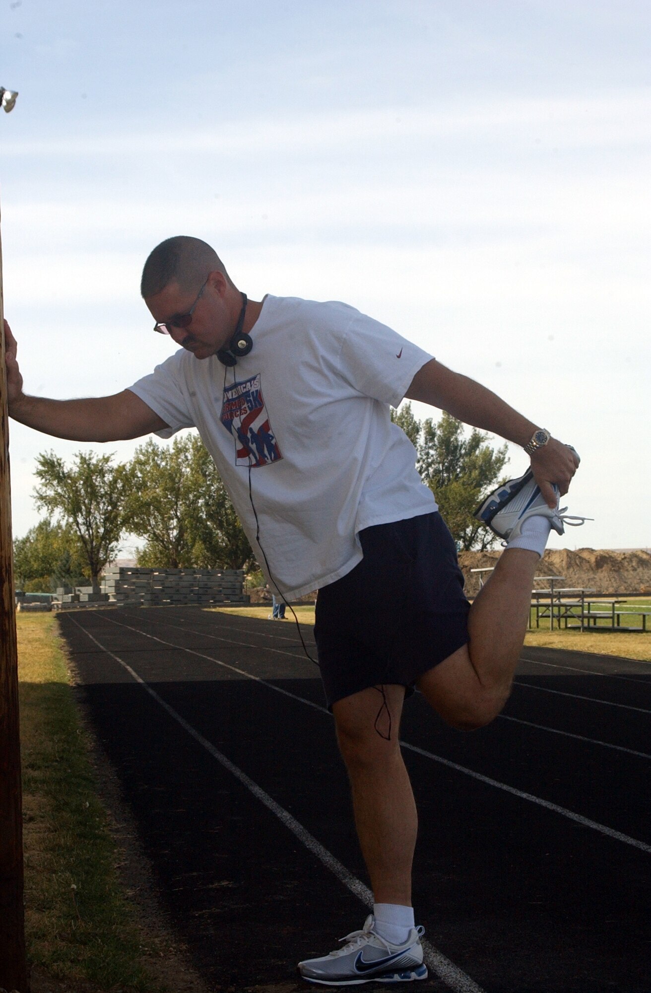Master Sgt. Jimmy Jackson, 341st Logistics Readiness Squadron first sergeant, stretches before starting one of his final workouts prior to departing Malsmtrom to compete in the Air Force Marathon Saturday. (U.S. Air Force photo/Valerie Mullett)