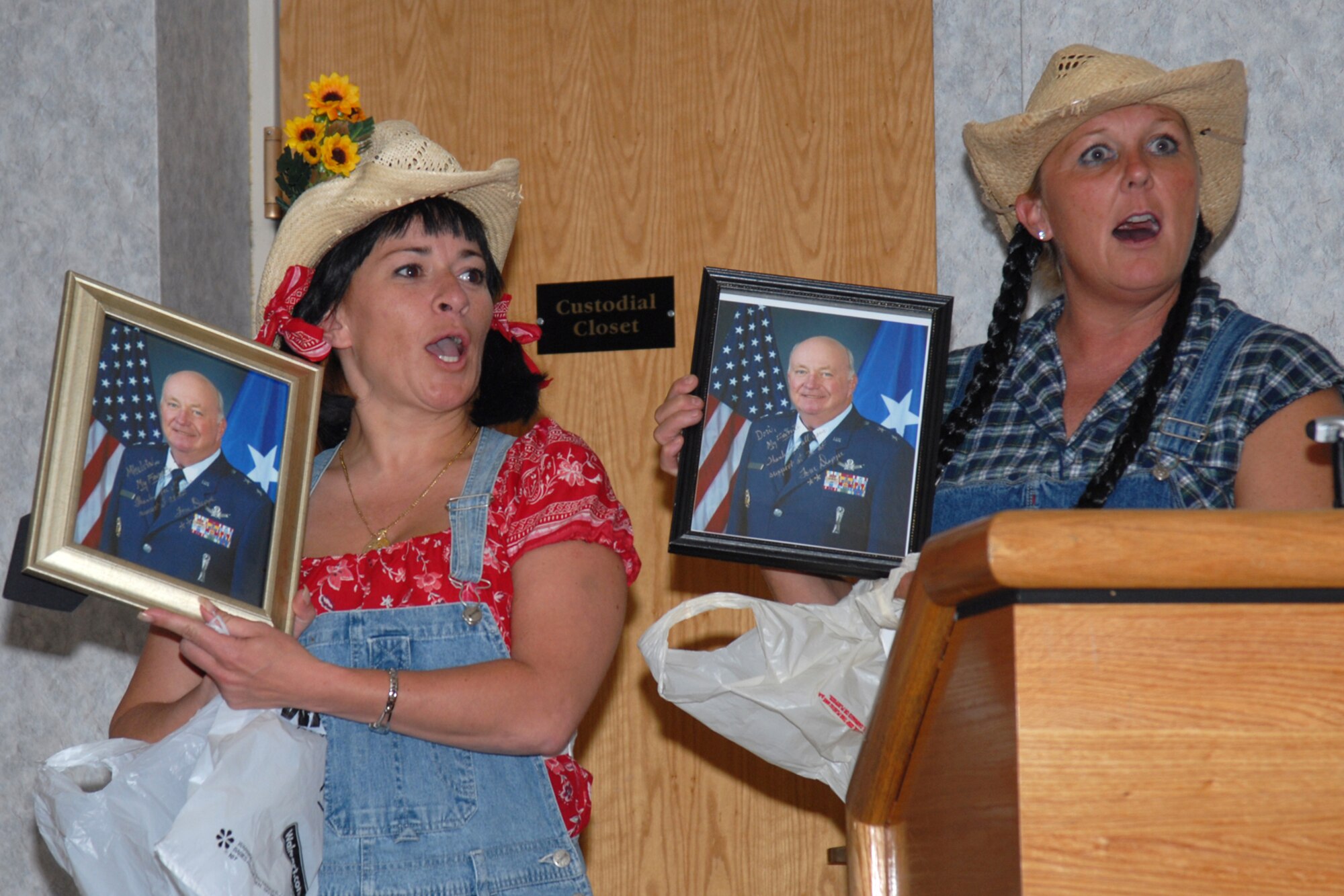 Master Sgt. Mhel Porter, Twentieth Air Force, and Master Sgt. Dori Batten, 90th Medical Operations Squadron, argue who is Maj. Gen. Tom Deppe’s favorite at General and Mrs. Eileen Deppe’s farewell party at the Trail’s End club Aug. 8. Attendees argued about the outgoing 20th Air Force commander’s favorites on topics ranging from Air Force bases to individuals. General Deppe’s next assignment is at Peterson Air Force Base, Colo., as the Air Force Space Command vice commander (Photo by Bernie Ernst).