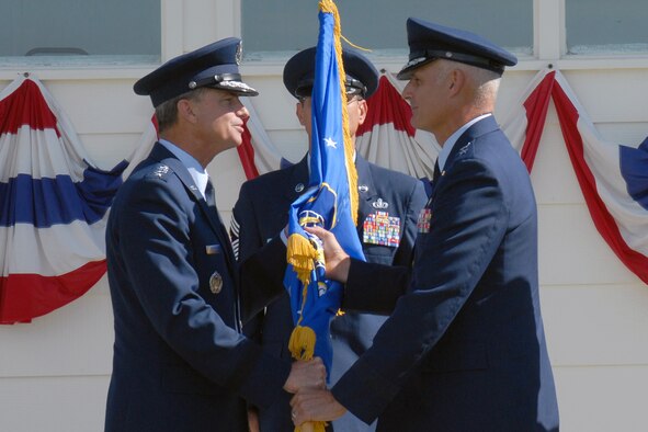 Gen. Kevin P. Chilton, Air Force Space Command commander, passes the Twentieth Air Force guide-on to Maj. Gen. Roger Burg, new 20th Air Force commander, during a change of command ceremony at Argonne parade field Aug. 10. General Burg assumed command over the 90th Space Wing here, the 91st Space Wing at Minot Air Force Base, N.D., and the 341st Space Wing at Malmstrom AFB, Mont (Photo by Bernie Ernst).