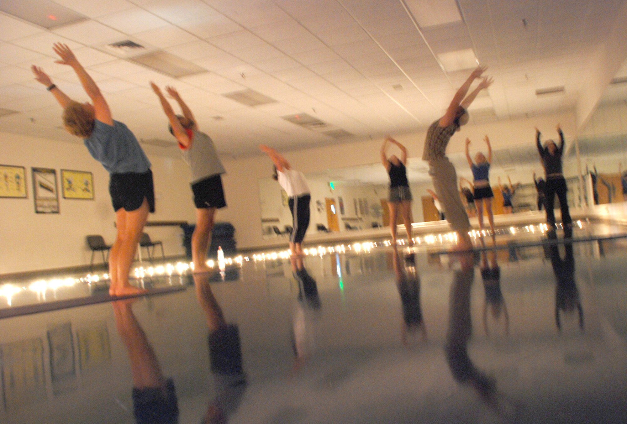 Power Yoga participants stand in the warrior position during a yoga session Aug. 2. The session also helps strengthen the body core. For more information on yoga and other aerobics classes, visit http://www.90svs.com (Photo by Airman Alex Martinez).