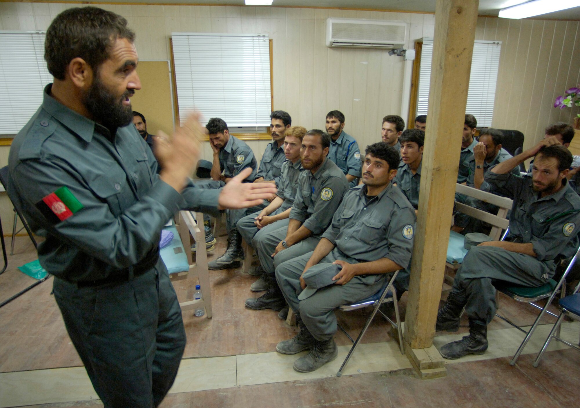 Afghan National Police Capt. Sanak teaches a class on the Afghanistan criminal code to Afghan National Auxiliary Police trainees Sept. 3. The trainees are attending a two-week ANAP sustainment course held on forward operating base Mehtar Lam in Afghanistan's Laghman province. The course is being taught for the first time entirely by ANP instructors. Previously, all ANP instruction was conducted by a police technical advisory team made up of U.S. Air Force security forces Airmen assigned to the Laghman Provincial Reconstruction Team. The PTAT's role has now shifted to monitoring the course's progress and mentoring the ANP instructors. The two-week course is required in order for auxiliary members to become full-fledged ANP officers. The course was written by PTAT members and approved by the Afghan interior ministry. Laghman is the first Afghanistan province to have Afghan instructors teaching an ANP course. The ANP instructors are competitively selected and must complete an instructor development course taught at a regional training center. (U.S. Air Force photo/Master Sgt. Jim Varhegyi)